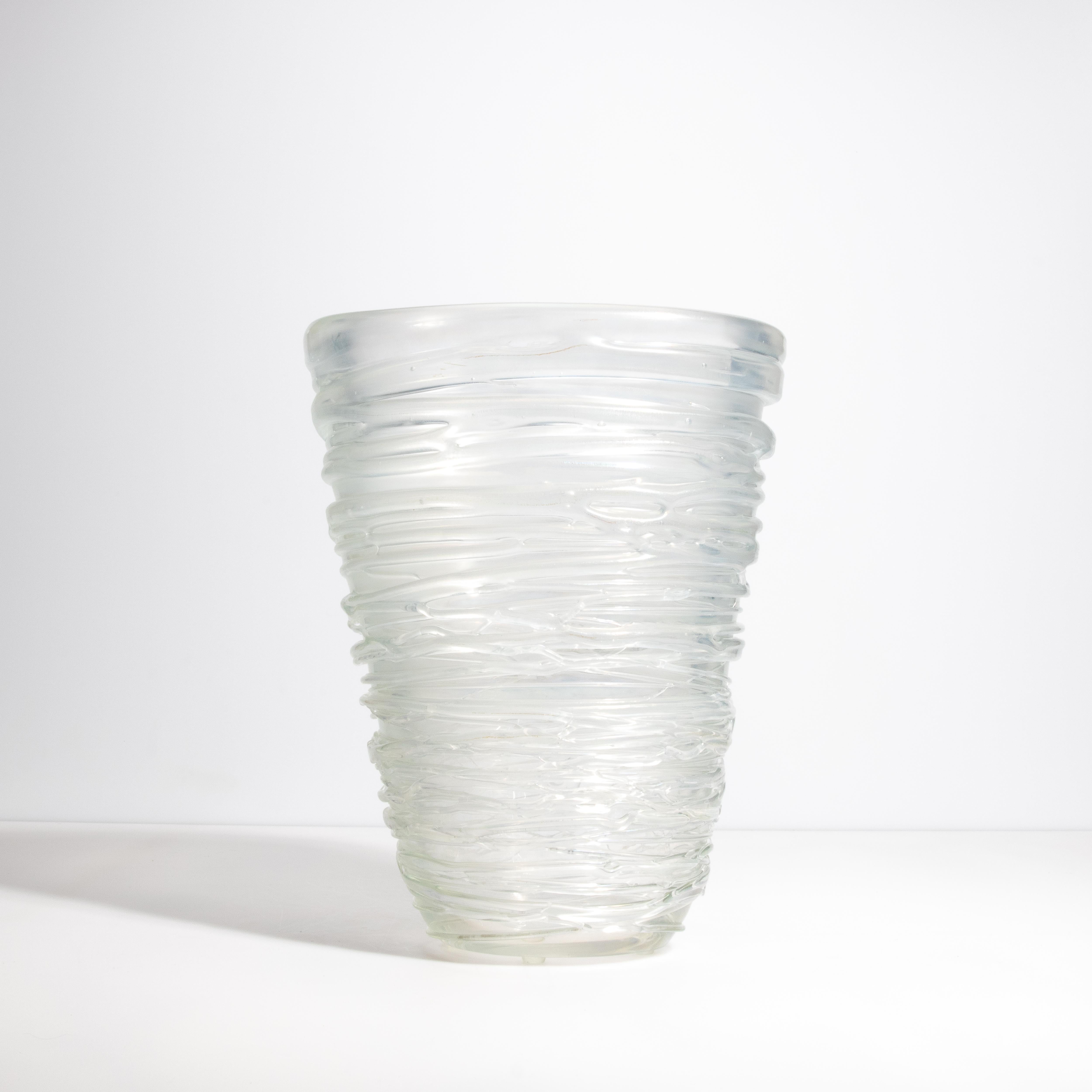 This exquisite Spiral Vase Frosted Medium is a masterpiece of contemporary design, embodying the timeless elegance of Murano glass craftsmanship. Each vase is meticulously hand-blown by skilled artisans, resulting in a unique, one-of-a-kind piece.