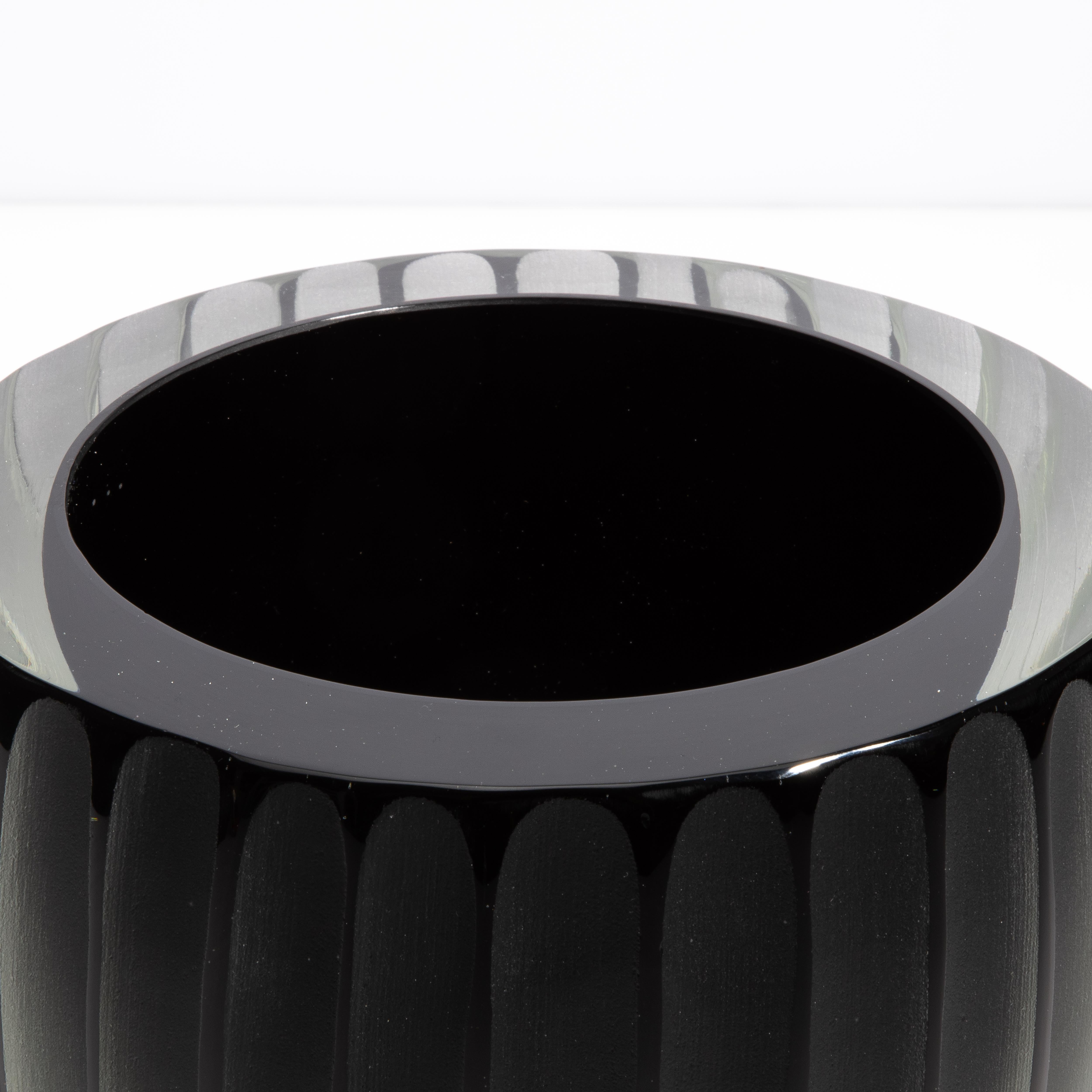 Ti presentiamo il Vaso Nero Supremo, una miscela magistrale di eleganza opaca e raffinatezza lucida. Realizzato a mano a Murano, in Italia, questo vaso è la testimonianza di secoli di squisita tradizione vetraria. La sua forma arrotondata è ornata