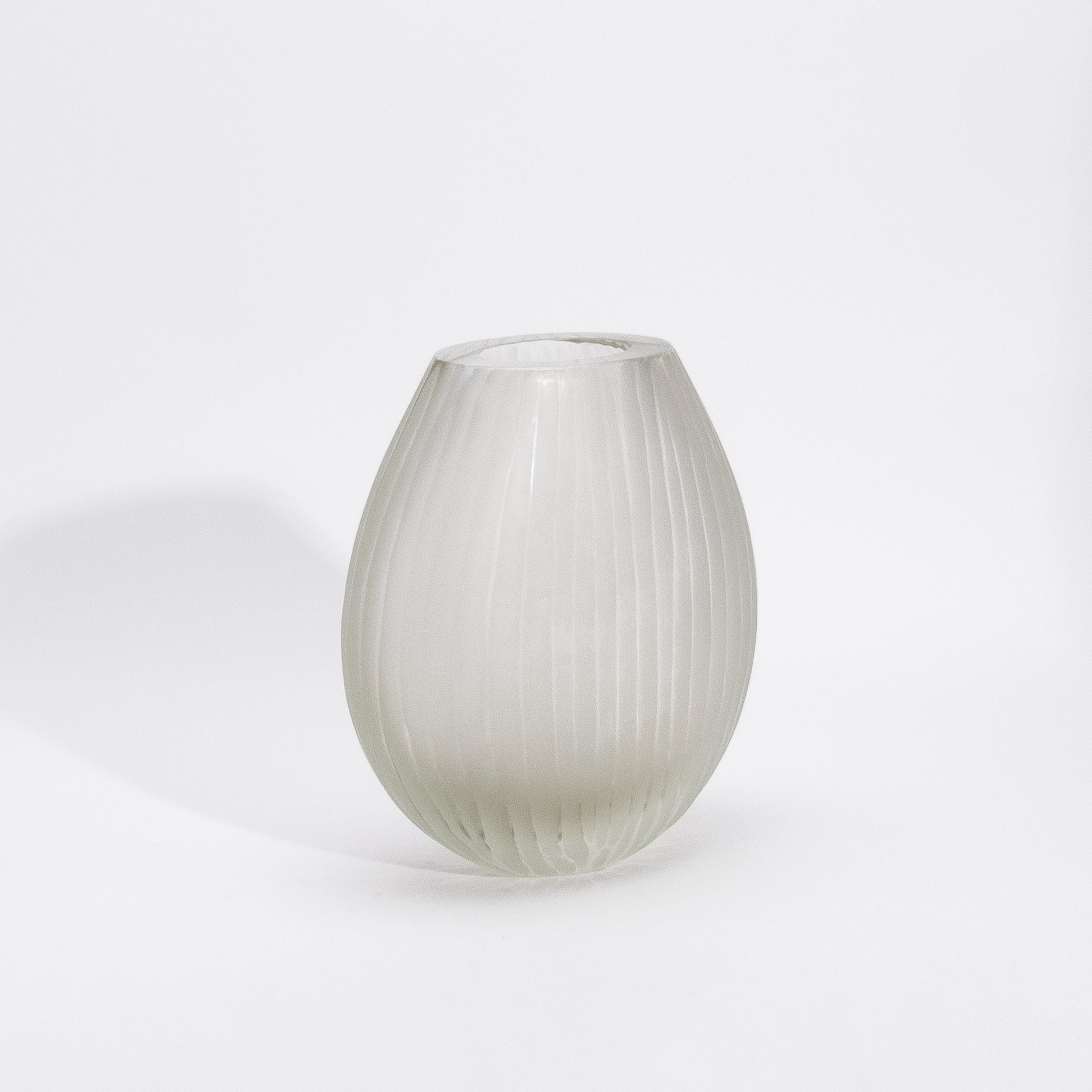 Crafted in the heart of Murano by master artisans, the Surpime Vase in Citrine embodies the serene elegance of fine Italian glassmaking. Its delicate golden tone, soft and luminous like morning mist, is encased in a frosted surface that lends an