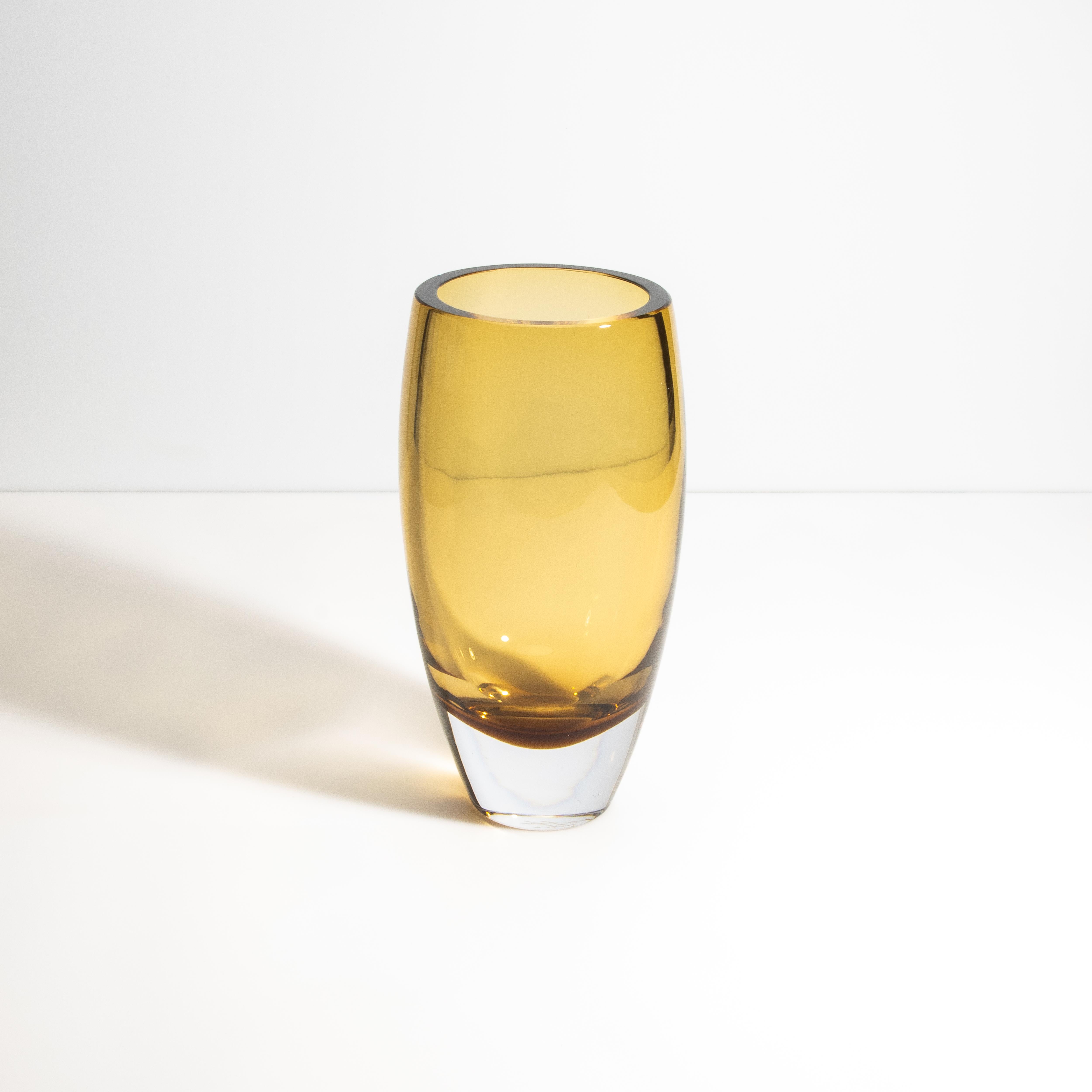 This piece is a striking example of modern Murano glass artistry. This piece stands out with its warm, amber hue that evokes the rich tones of tobacco leaves, encapsulated in a sleek, rounded form. The exterior showcases the mastery of traditional