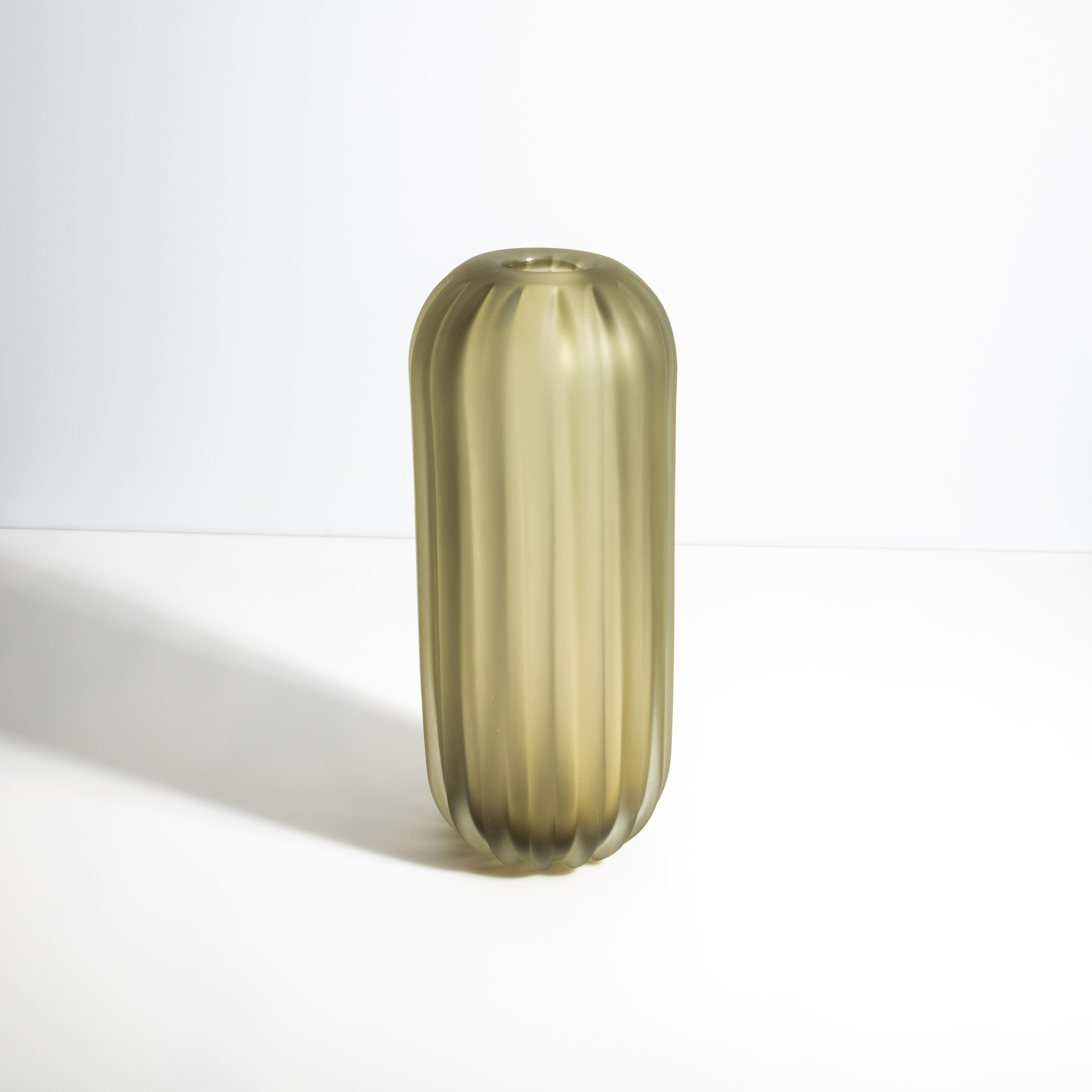 Inspired by the natural beauty of the desert, this Murano glass vase captures the essence of elegance and simplicity. The matte olive finish and ribbed texture playfully display the organic lines of a desert cactus, blending modern design with a