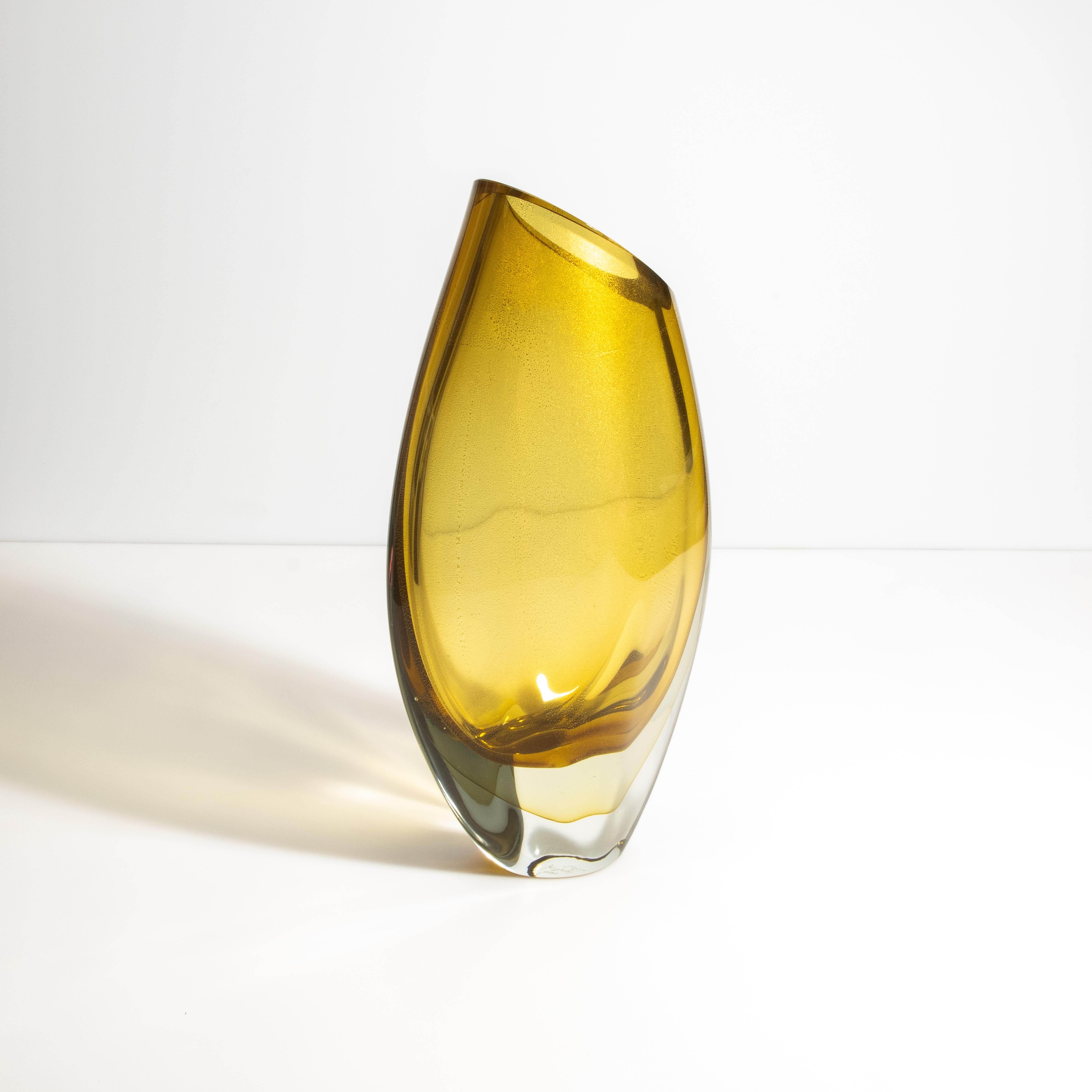 Diese exquisite Vase mit 24-karätigen Goldflecken bringt einen Hauch von italienischem Sonnenlicht in Ihre Räume. Der goldene Bernsteinton der Vase, der an die warmen Farbtöne der Weinberge in der Toskana während der Erntezeit erinnert, strahlt