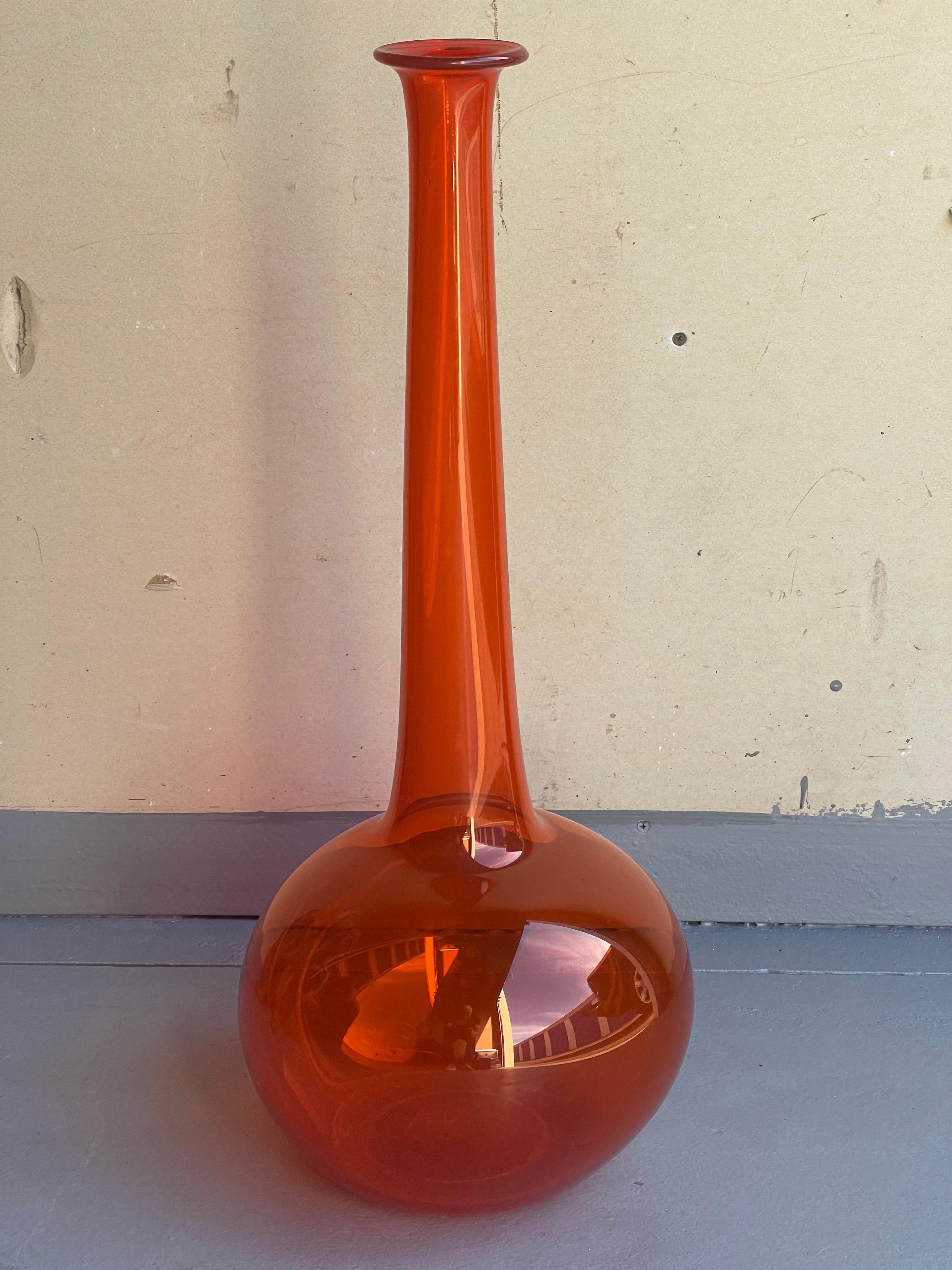 A very cool hand blown bright orange art glass vase in the style of Don Shepherd for Blenko Glass, circa 1980s. The piece is in very good vintage condition with no chips or cracks and measures 11