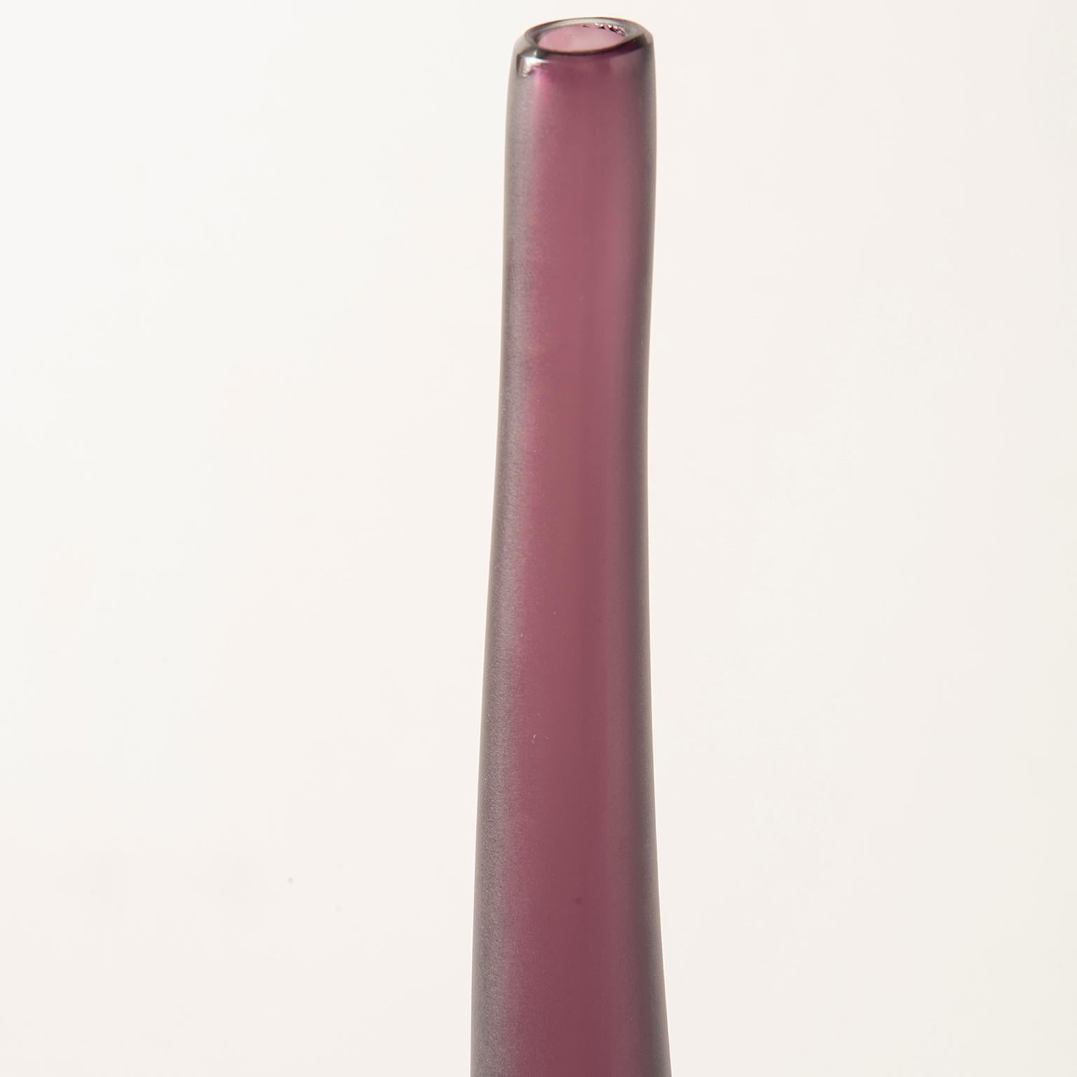 Designed and signed by artist Laura de Santillana for Arcade Murano glass, hand blown vase is #156 from a limited edition of 300. Just under two feet tall, this narrow vase is deep plum in color. New, limited edition with no flaws found.