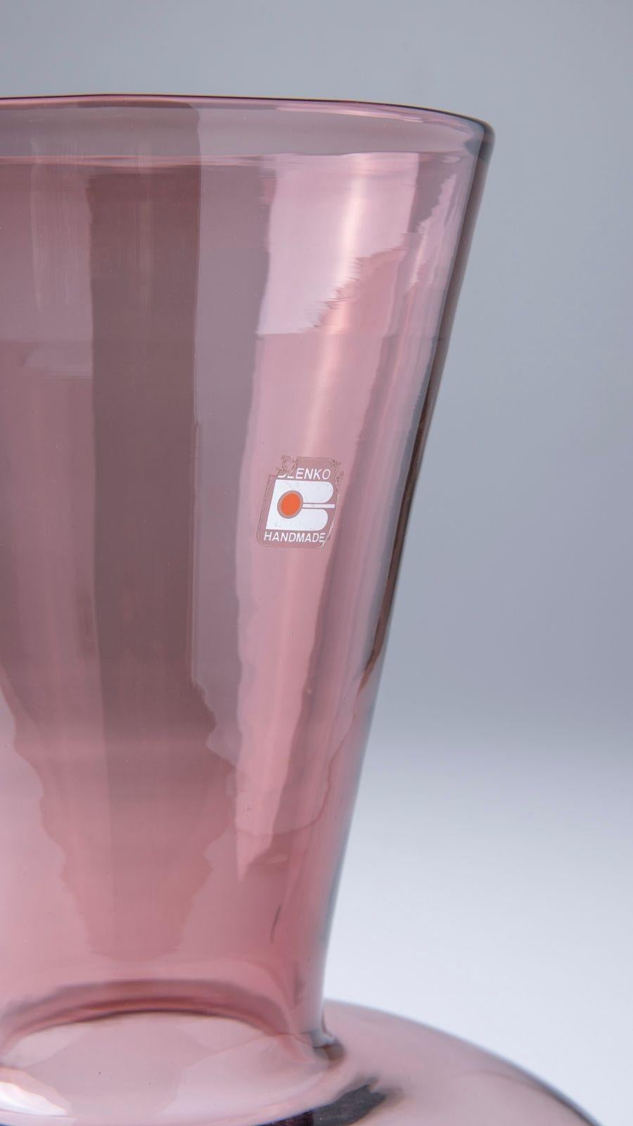 Beautiful hand-blown glass vase by Blenko in a light plum. Vase is in excellent condition and measures 13