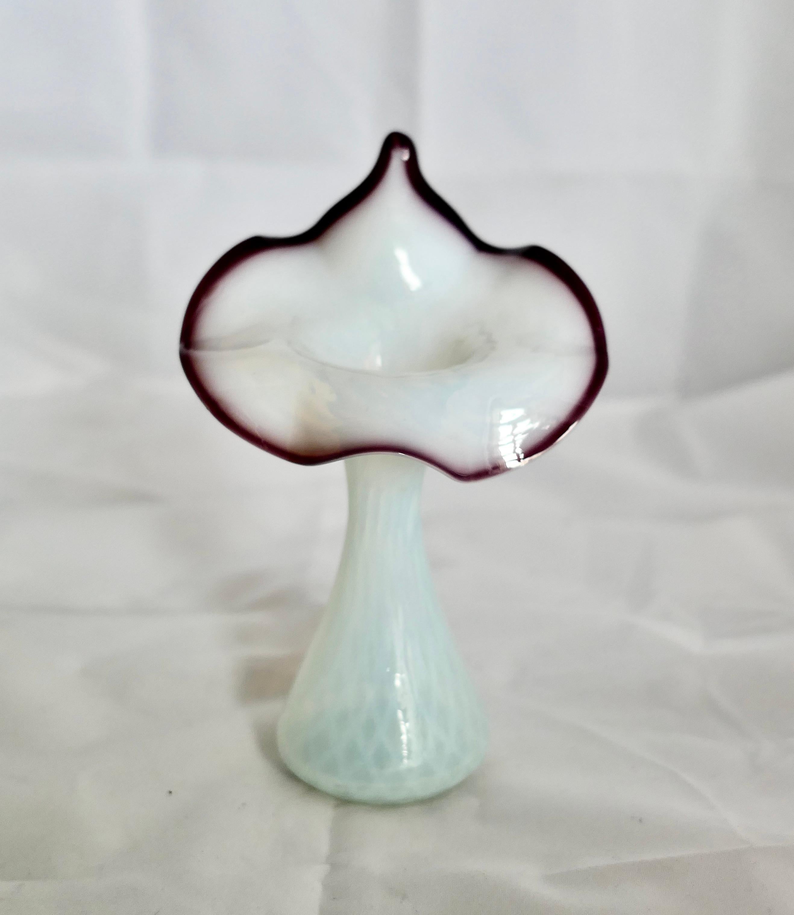 Hand Blown Victorian Semi Opalescent Jack in the Pulpit Vase

A delightful example of a Jack in the Pulpit Vase, this one is semi opalescent with a Burgundy edge to the Lilly 
No Chips or Cracks
The Vase is 7” tall and 4” in Diameter
FB152