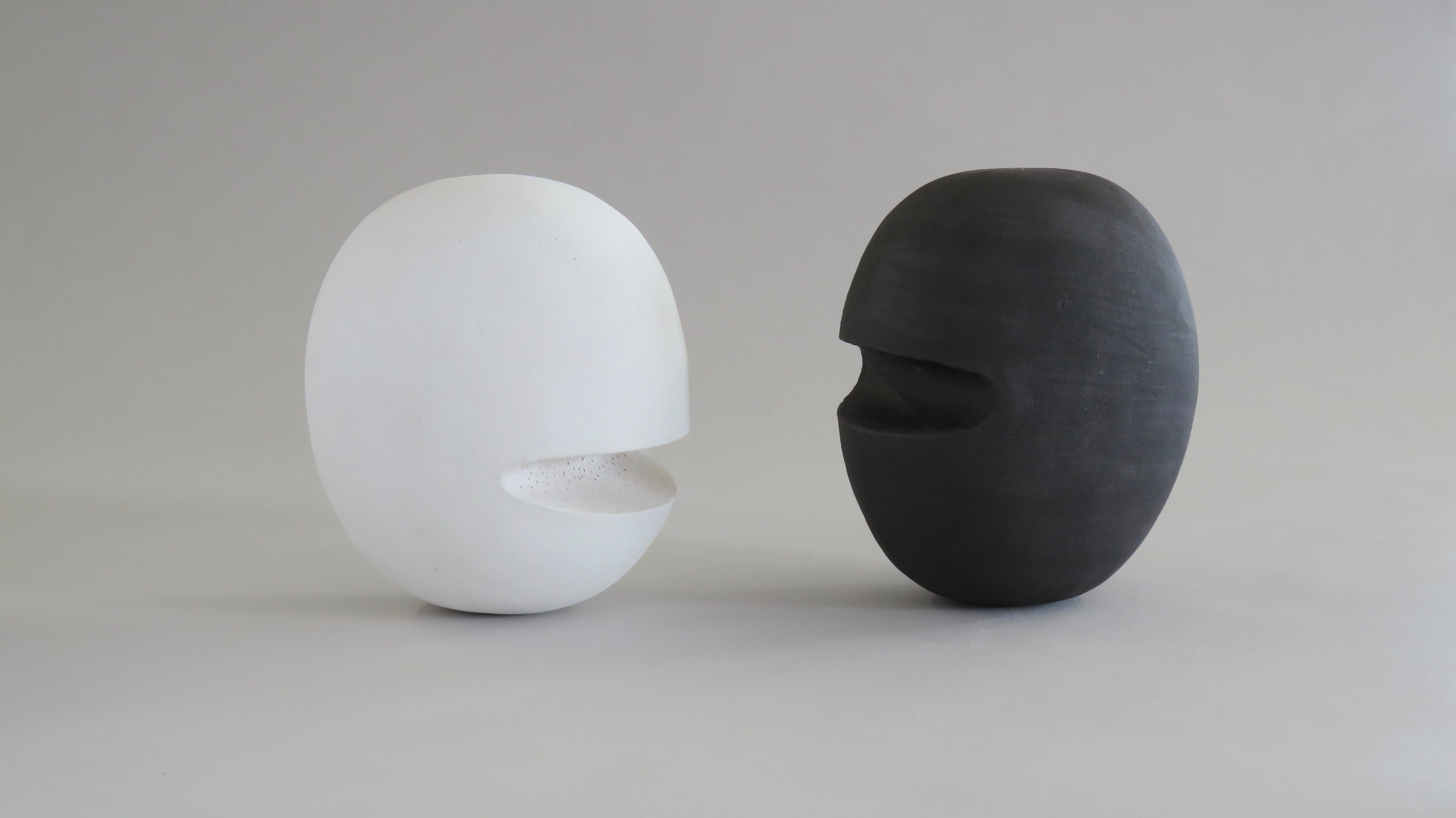 Hand-Built Ceramic Heads, hollowed out in the construction for lightness, they are finished in a soft matte white underglaze. Inspired by the need for better communication in the world, this series of heads may stand or lie, sometimes where the
