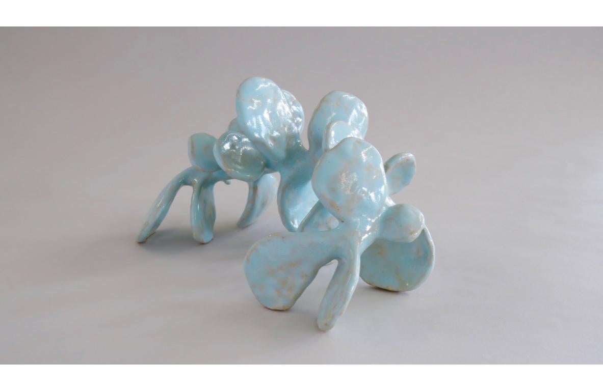 This unique turquoise hand built sculpture is made of stoneware clay and has a dreamy layered turquoise glaze for added depth of color and tone. In fact, the glaze reveals tones from the buff colored clay. Since it is fully hand formed and glaze