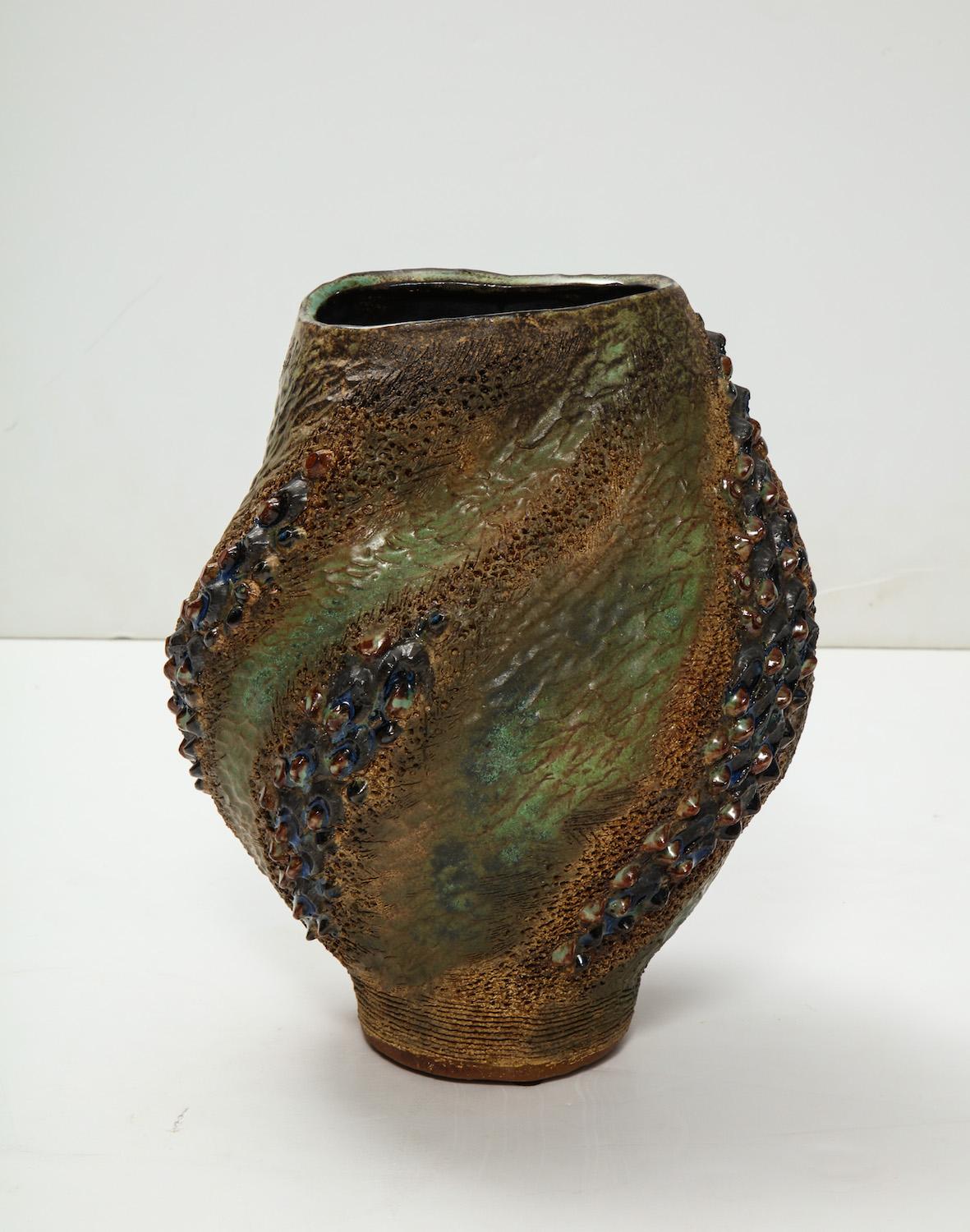 Hand-built earthenware vase with texture and movement throughout. Great earth tone glazes suggesting flames. Artist-signed and dated on underside.