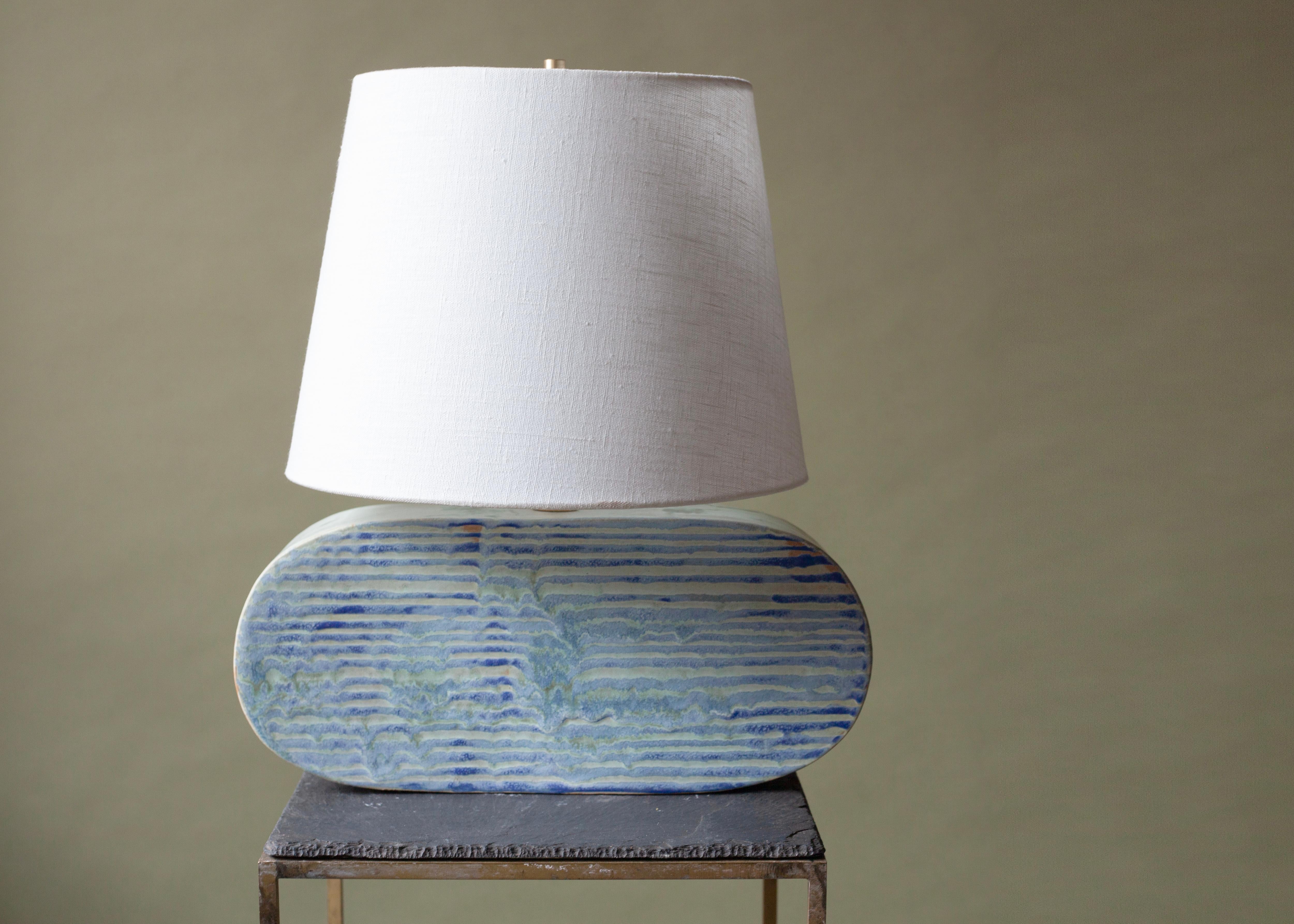 Hand-Built Ceramic Table Lamp with Linen Shade — Inspired by the New England Coast
This one-of-a-kind table lamp is entirely hand-built and assembled, celebrating the artistry of traditional craft and the organic beauty of natural forms. The base is