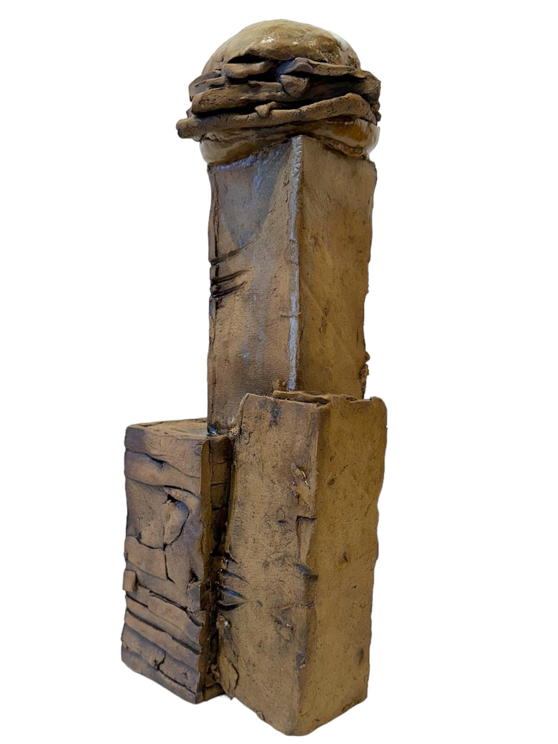 This ode to an American classic is a chunky, hand built sculpture depicting a group of columns with a ceramic hamburger atop.  Its earthenware coloring is complemented by the smallest amount of white drip glaze.

Steve Banks
Ode to