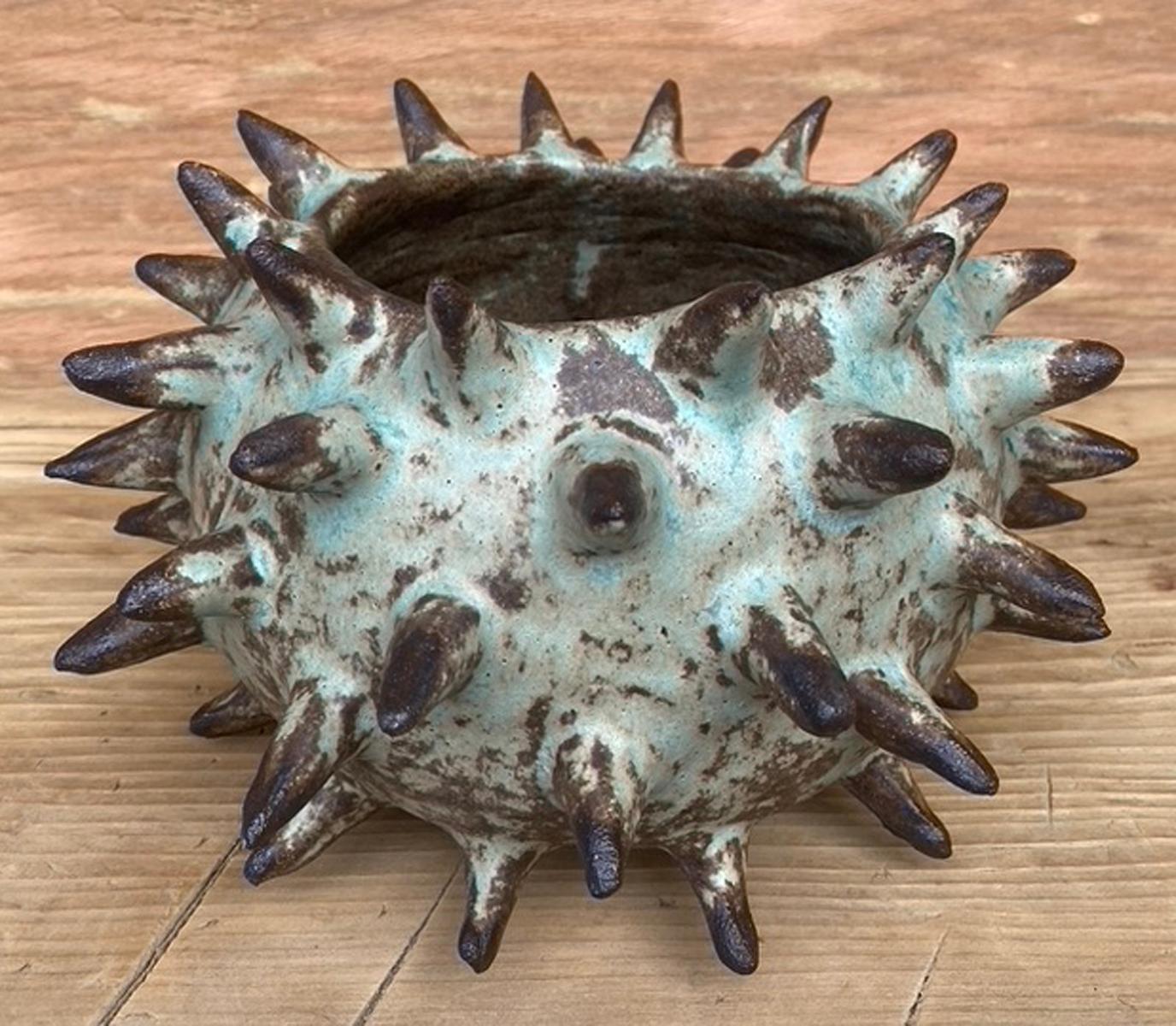 Hand built spike vessel. Glazed inside and outside. High fire. Cone 10.
Made by Santa Barbara based artist Sally Terrell. This particular one is part of a series with two other ceramics, see close up photos. Sold separately.