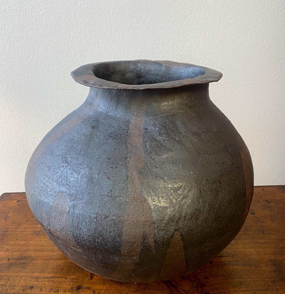 Hand built clay pot by ceramic artist Sally Terrell of Santa Barbara, California. Dark, high fired clay with glaze.