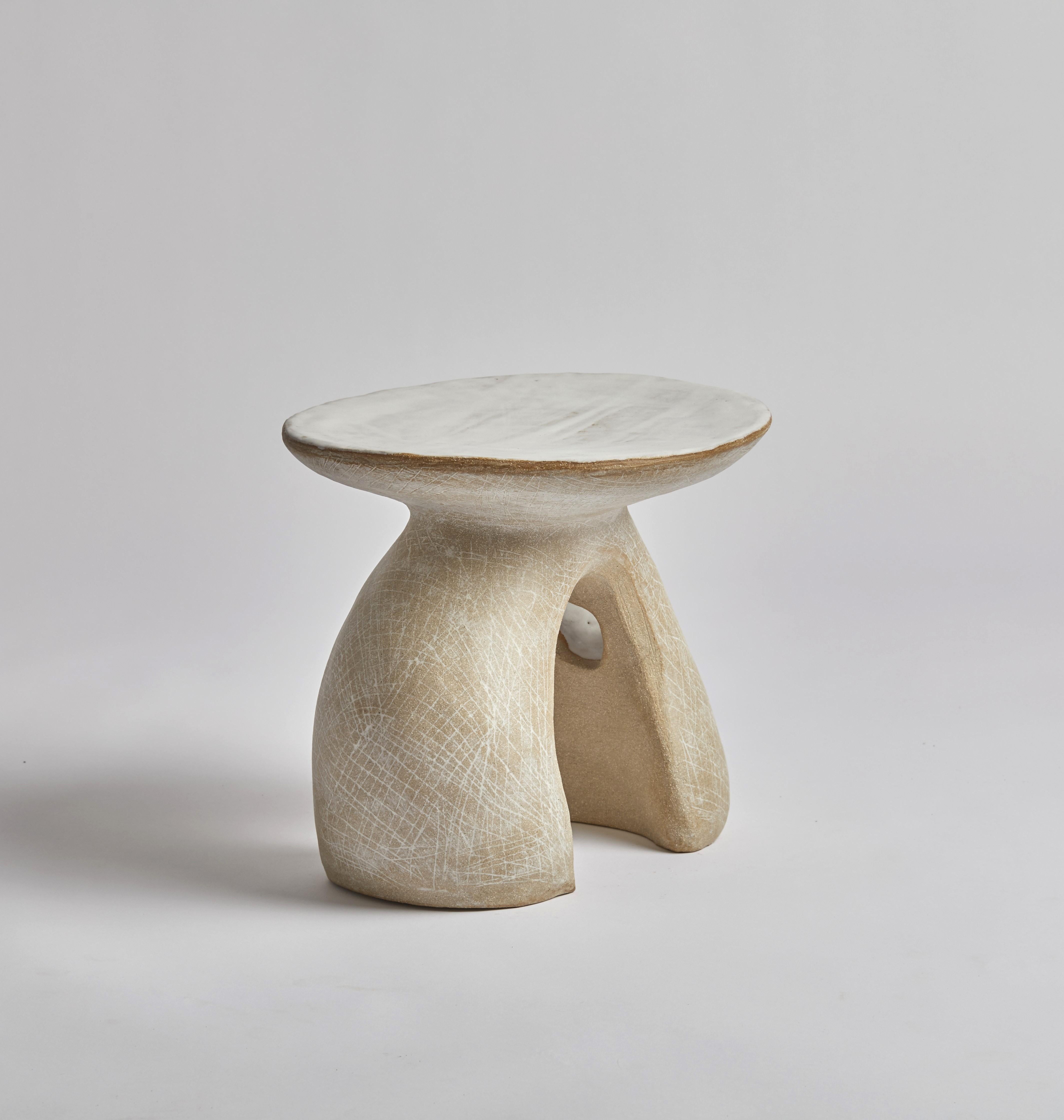 This side table has been hand built by it's creator, Kerry Hastings.  Inspired by sculptors such as Jean Hans Arp and Barbara Hepworth Kerry has used a blend of two clays, a toasted brown stoneware and white stoneware, to create this unique piece. 