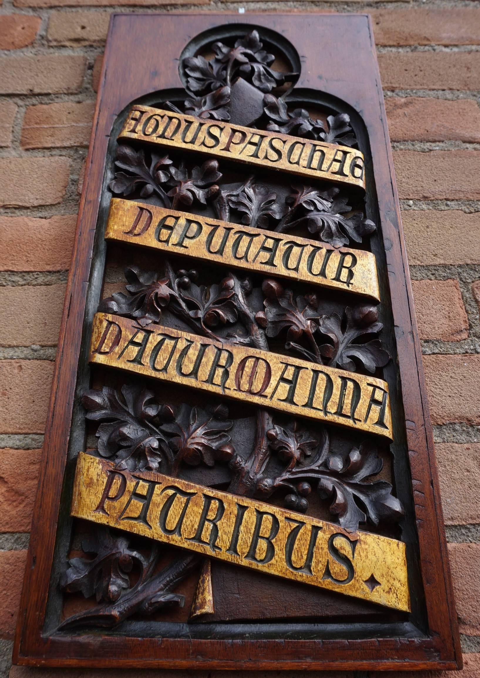 1800s Gothic wall panel with Latin phrase carved in a carved ribbon.

This incredibly well carved panel is in excellent condition and it has the most beautiful patina. The shape of the open carved centre is exactly like the shape of the windows in