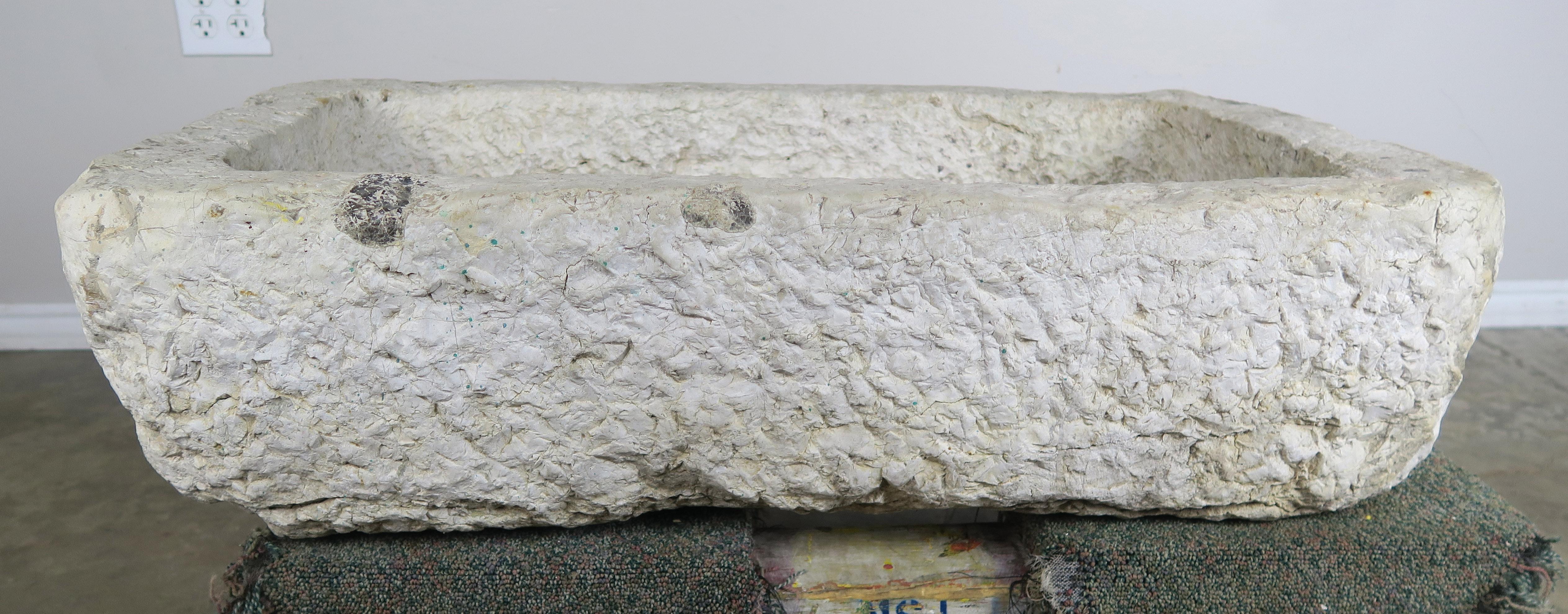 Hand carved 19th century French limestone sink with bottom drain hole.