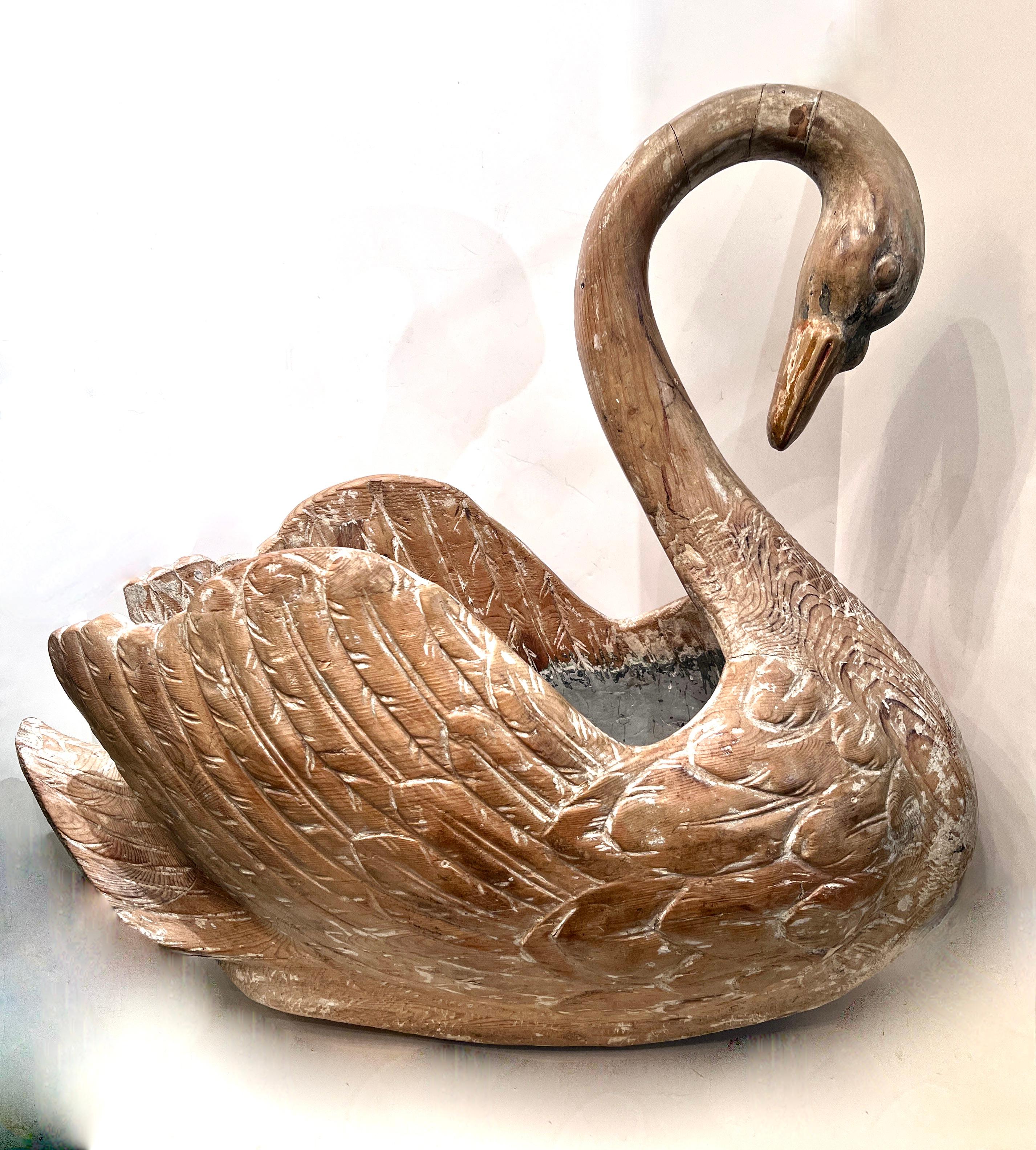 A beautifully hand carved Swan - the aged wood has a wonderful patination and the carving is exquisite.  This would make a great stand alone centerpiece or even a lovely addition to a large console or on the floor.  The inside is free and with a