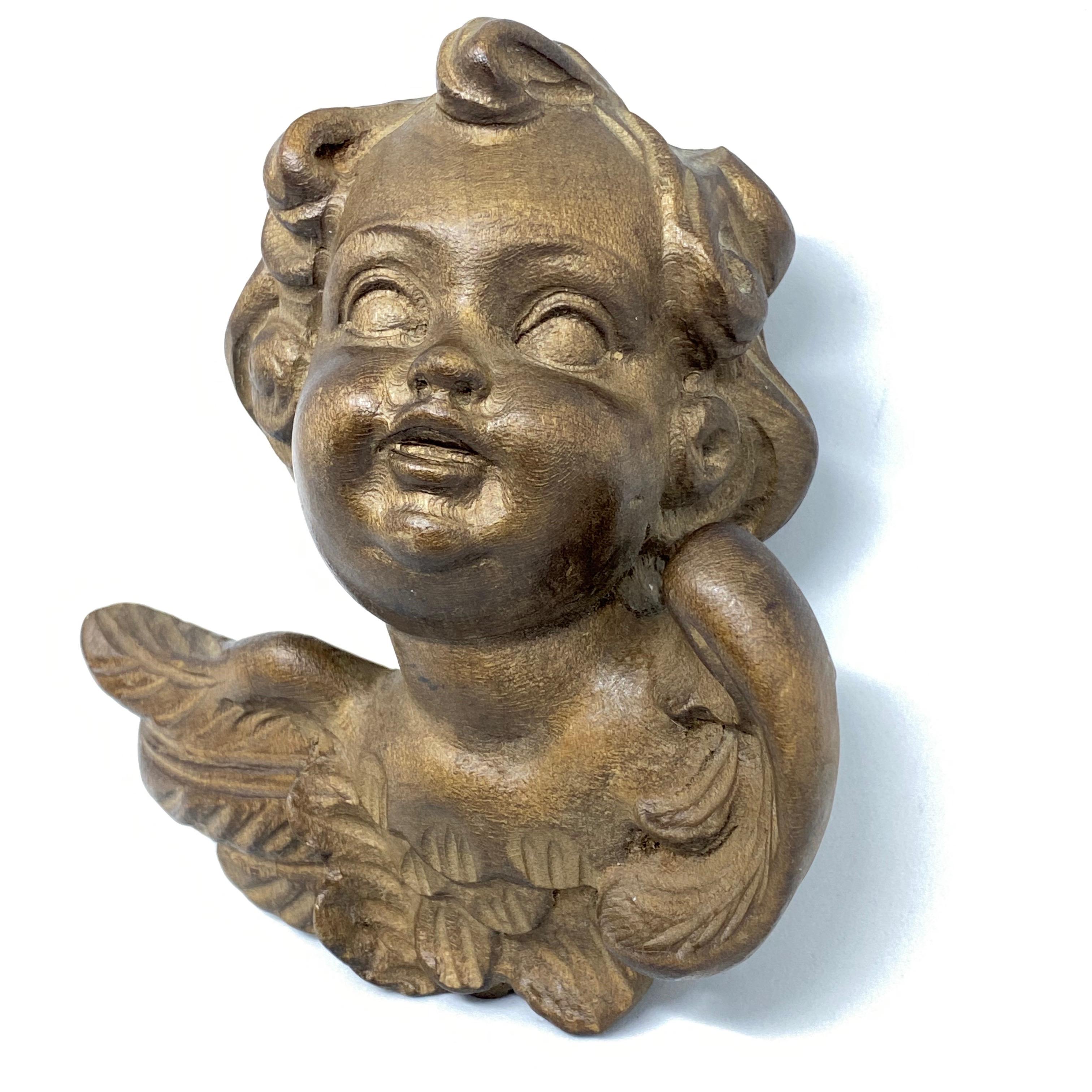 Beautiful hand carved wooden cherub angel head, found at an estate sale in Germany. We believe that this piece is from the mid-20th century. A nice addition to any room.
 