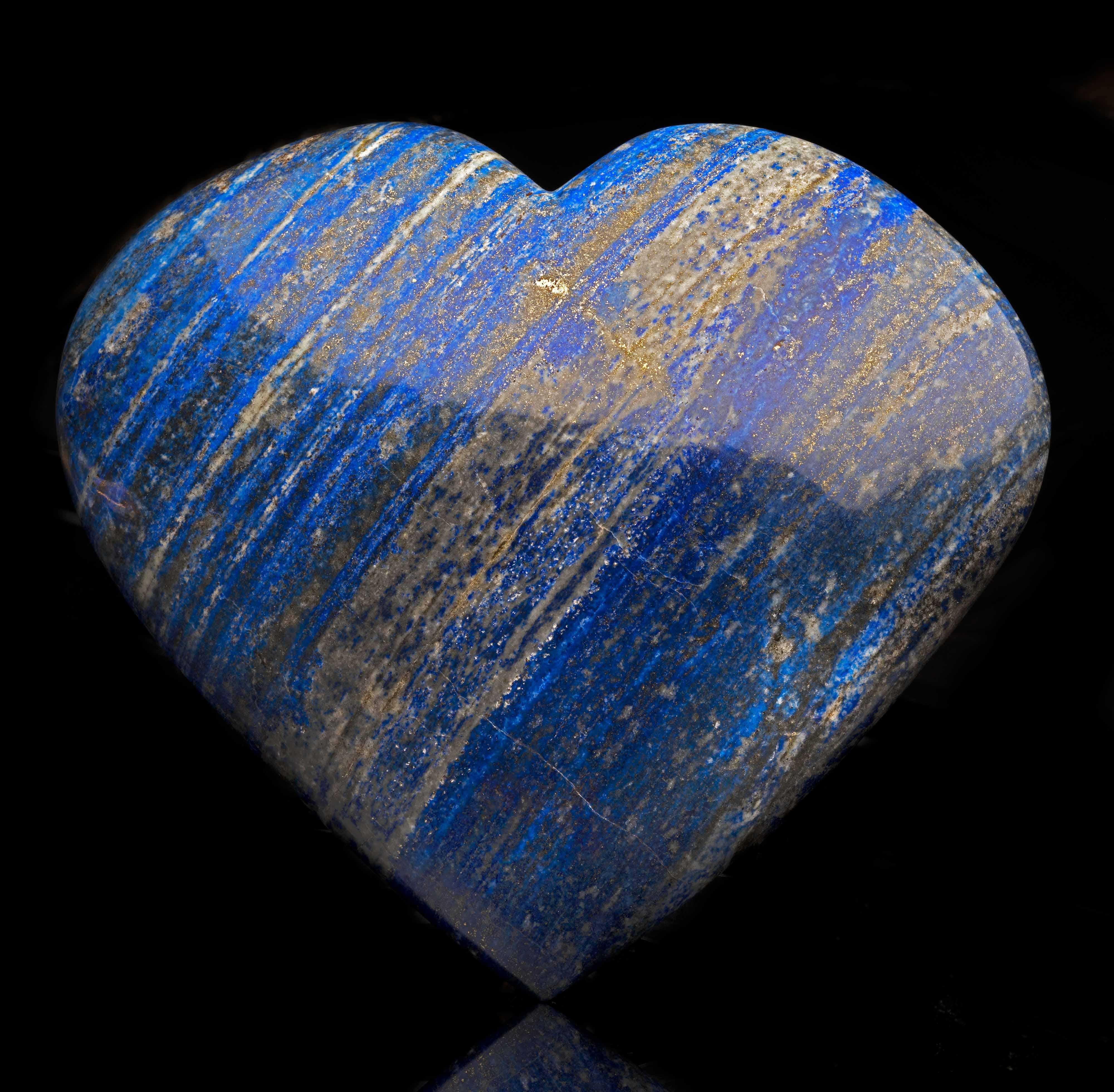 This huge heart from Afghanistan has been hand-carved and hand-polished out of one piece of genuine, beautiful color lapis lazuli featuring the shimmer of pyrite deposits and bands of white calcite which contrast beautifully with the royal blue base