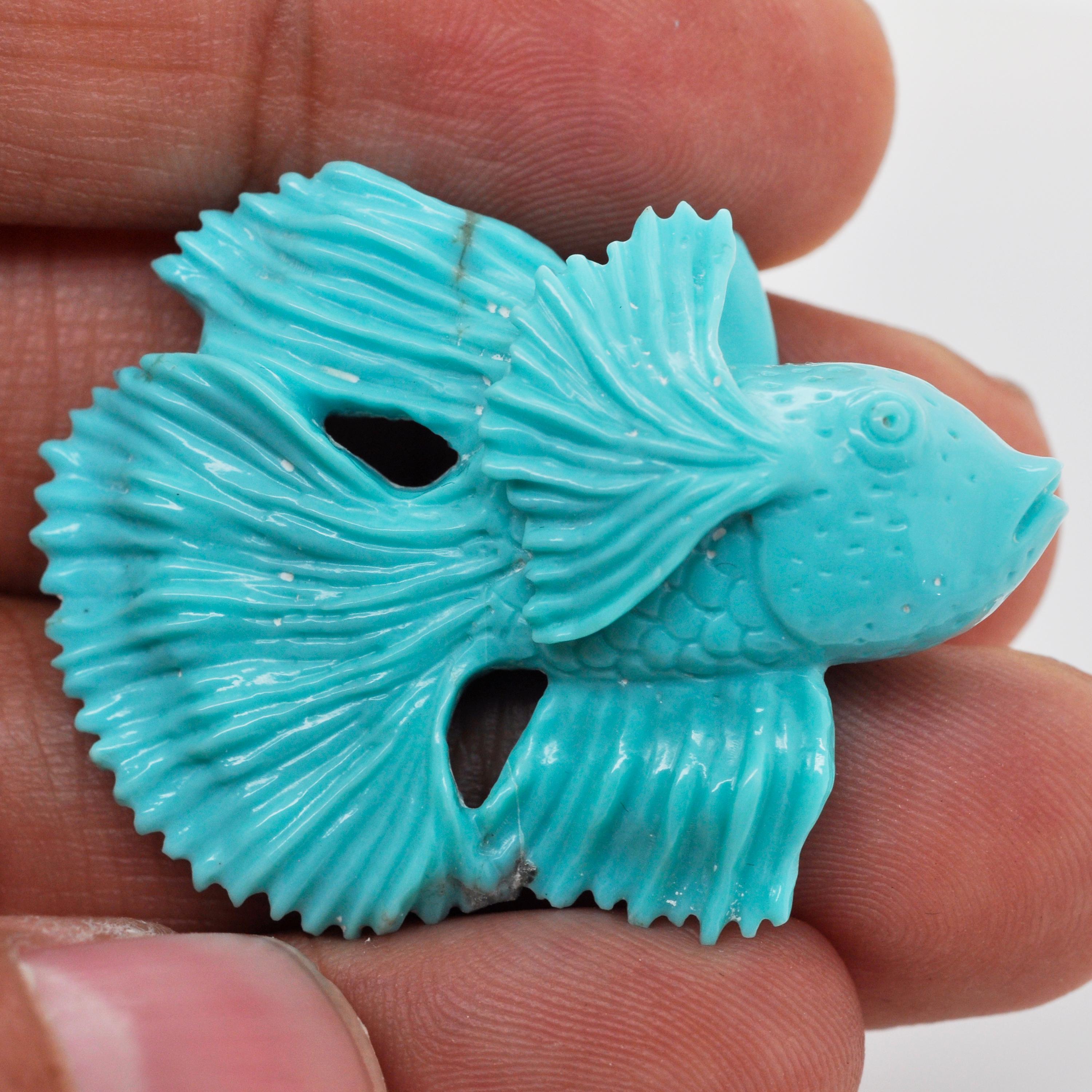 Our one-of-a-kind 42.23 cts hand-carved fish on natural Arizona Turquoise is a mesmerizing piece of art created by our expert lapidary artist in Jaipur. With exceptional skill and attention to detail, the lapidary artist has transformed a raw stone