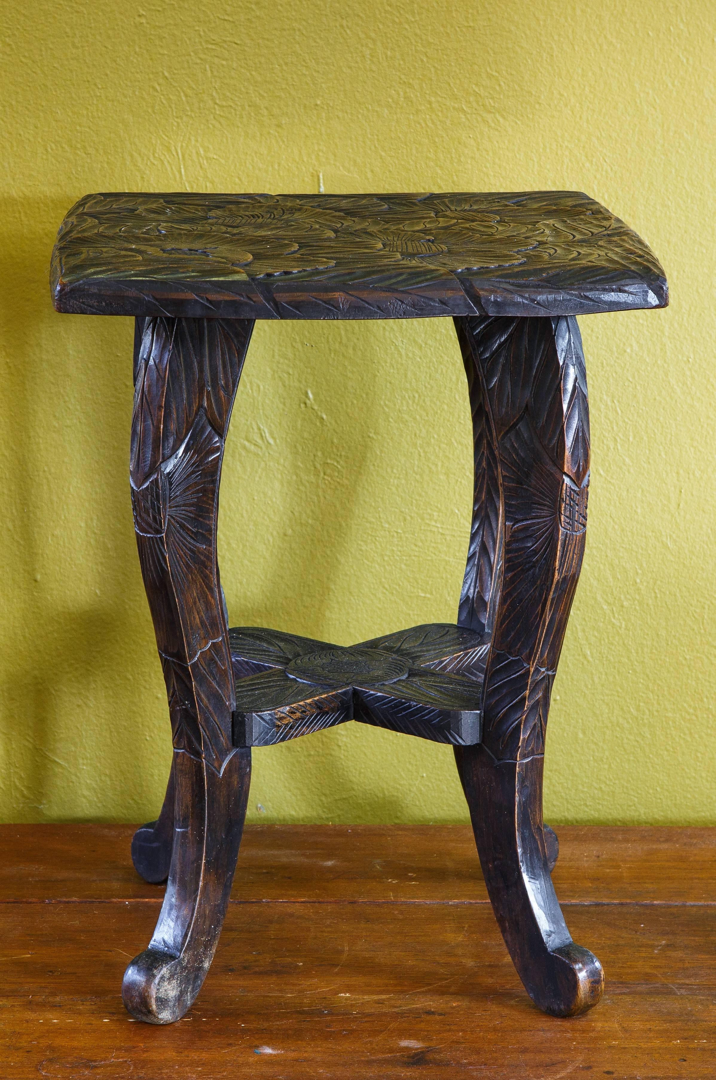 Wonderful, hand-carved floral stool/table. An exuberant stylized flower and leaf pattern covers the top of the table. A simpler corresponding
pattern continues down the legs.