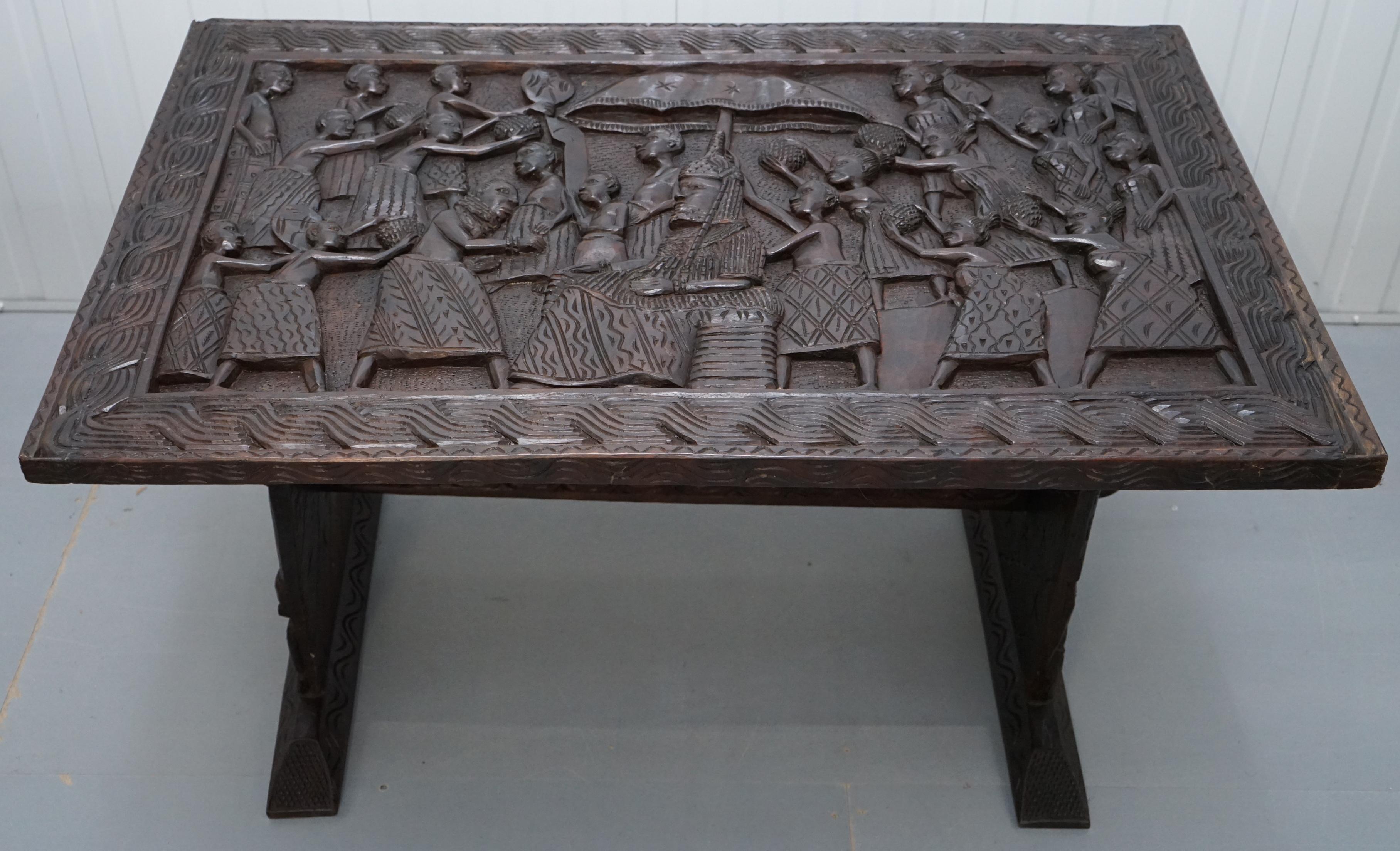 We are delighted to offer for sale this nice hand-carved African wood dining table depicting a Benin and his followers

In terms of condition its used and has patina marks all over, the table is very primitively made and hand carved, as such there