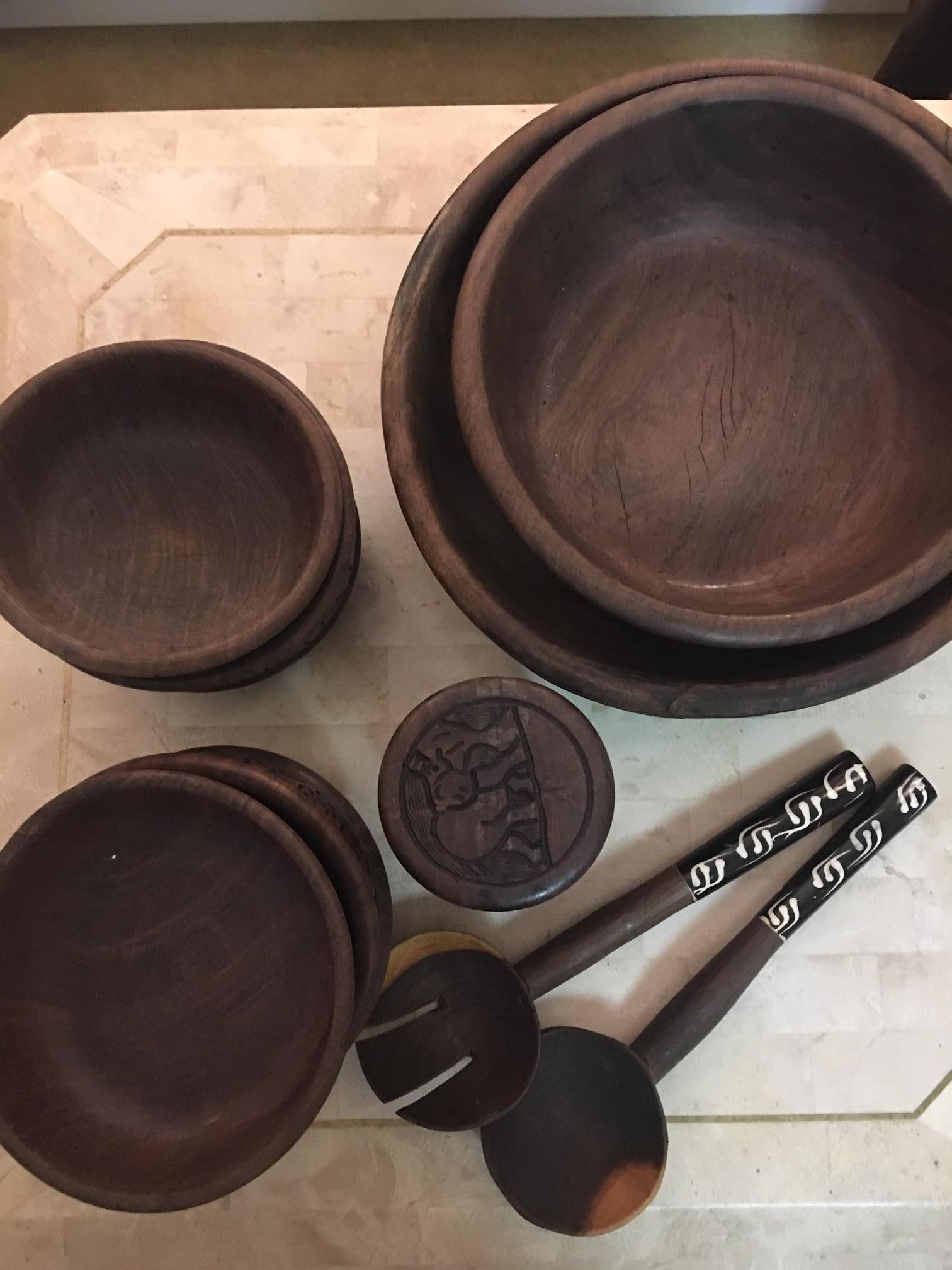 This African hand carved serving set consists of two serving utensils, two large serving bowls, the largest of which is 15