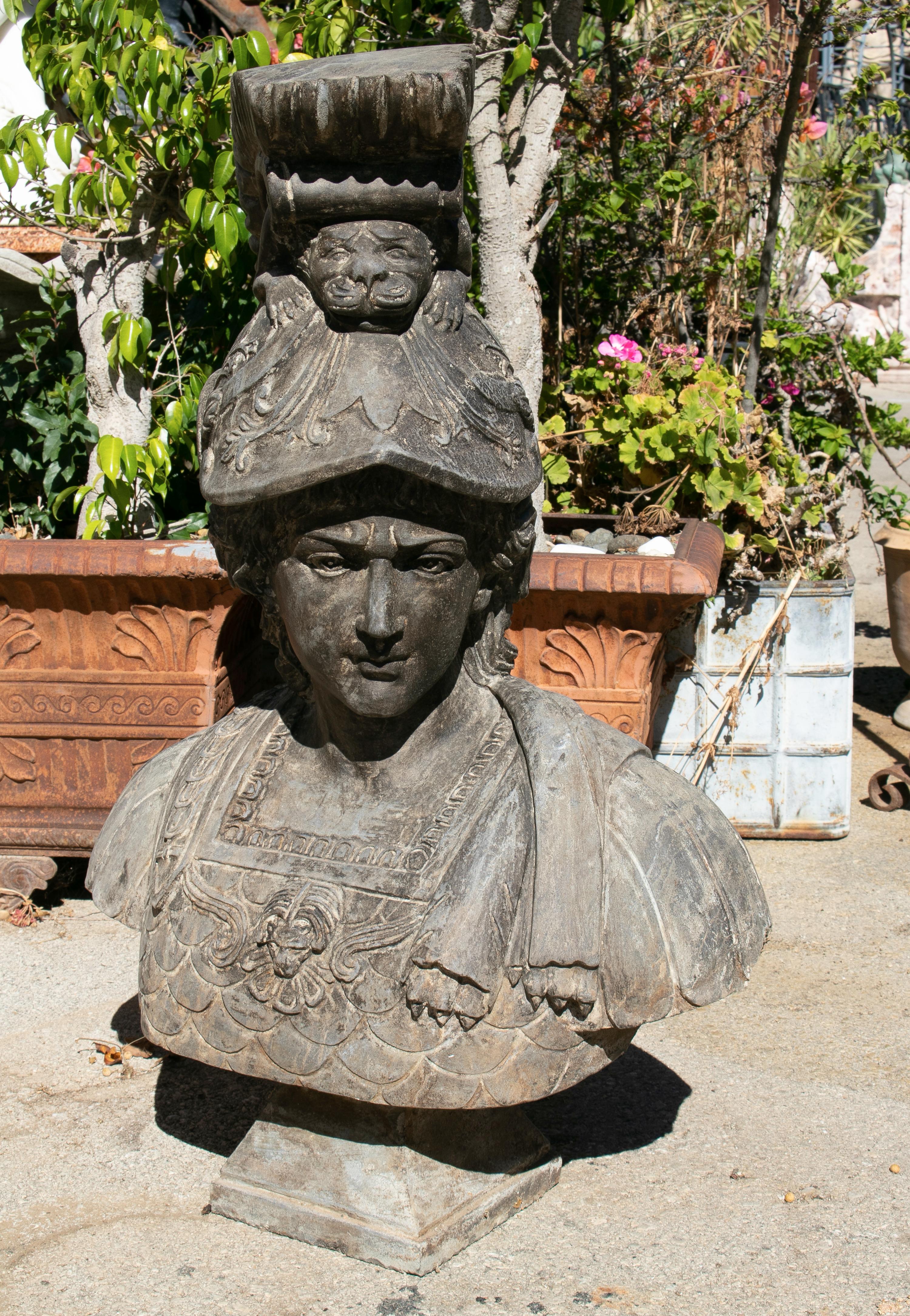 Hand carved marble bust of woman with helmet and toga, that has been aged to look antique.