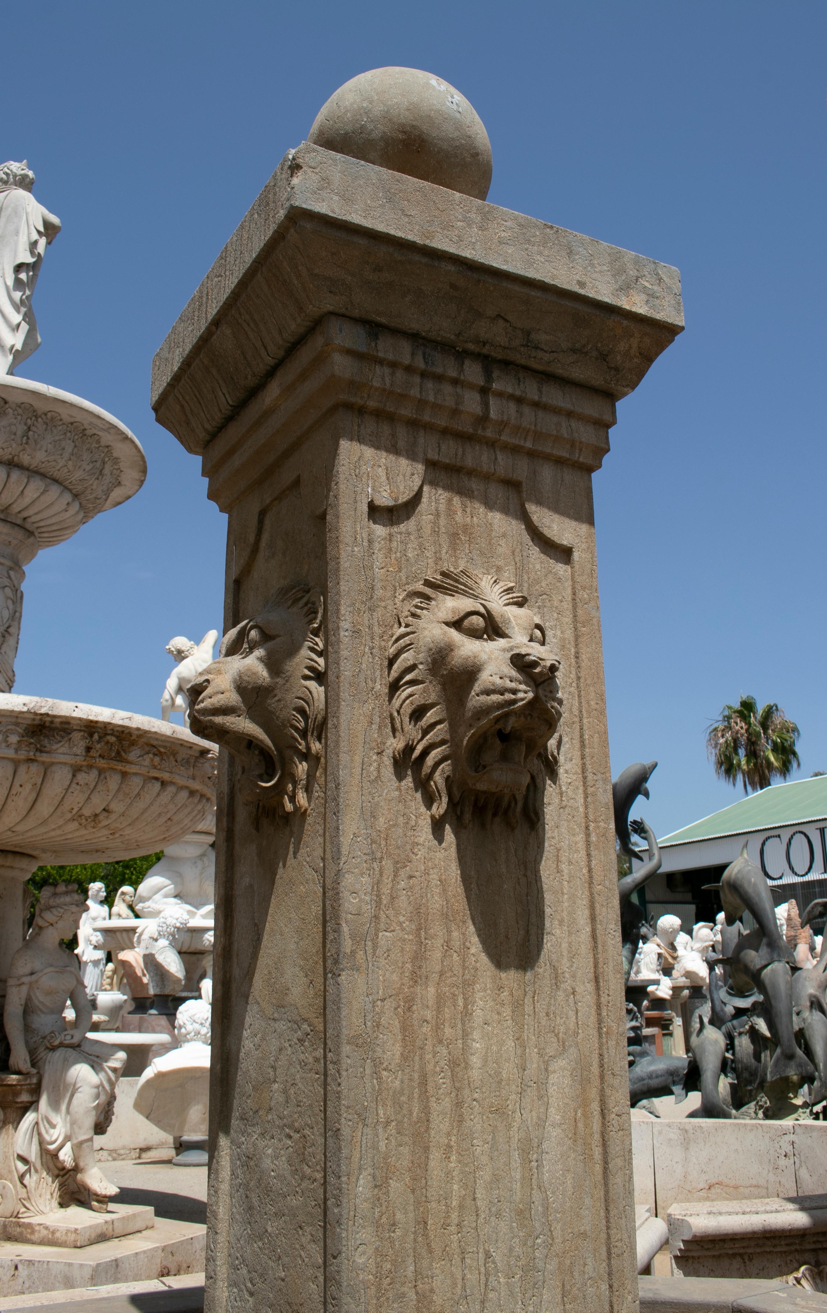 Hand carved marble fountain with pool and four lion heads with unique ageing technique that gives it an antique feel.