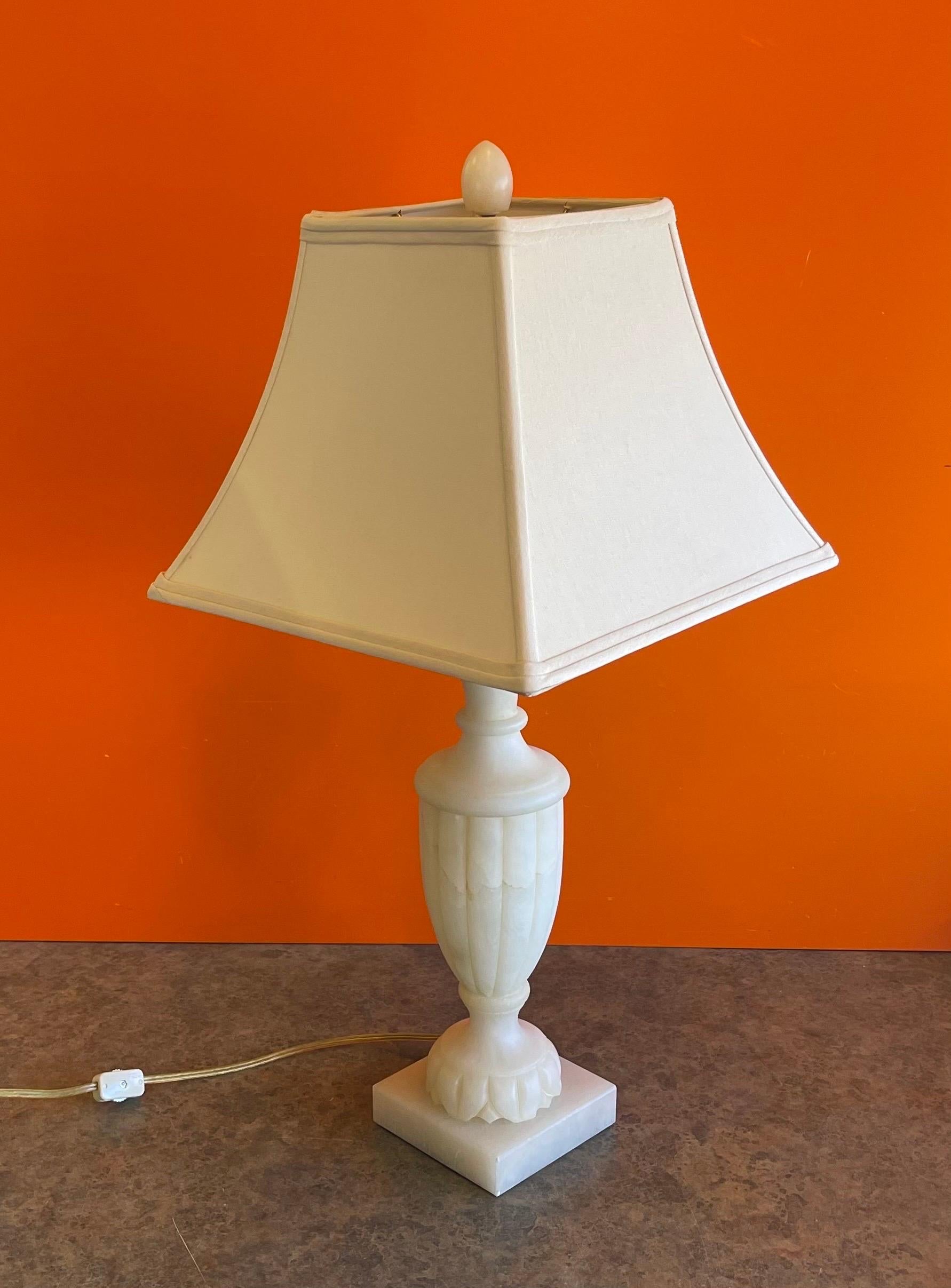 A really nice hand carved alabaster table lamp by Sarreid, Ltd of Spain, circa 1990s. The lamp is in very good condition with no chips or cracks and measures 26