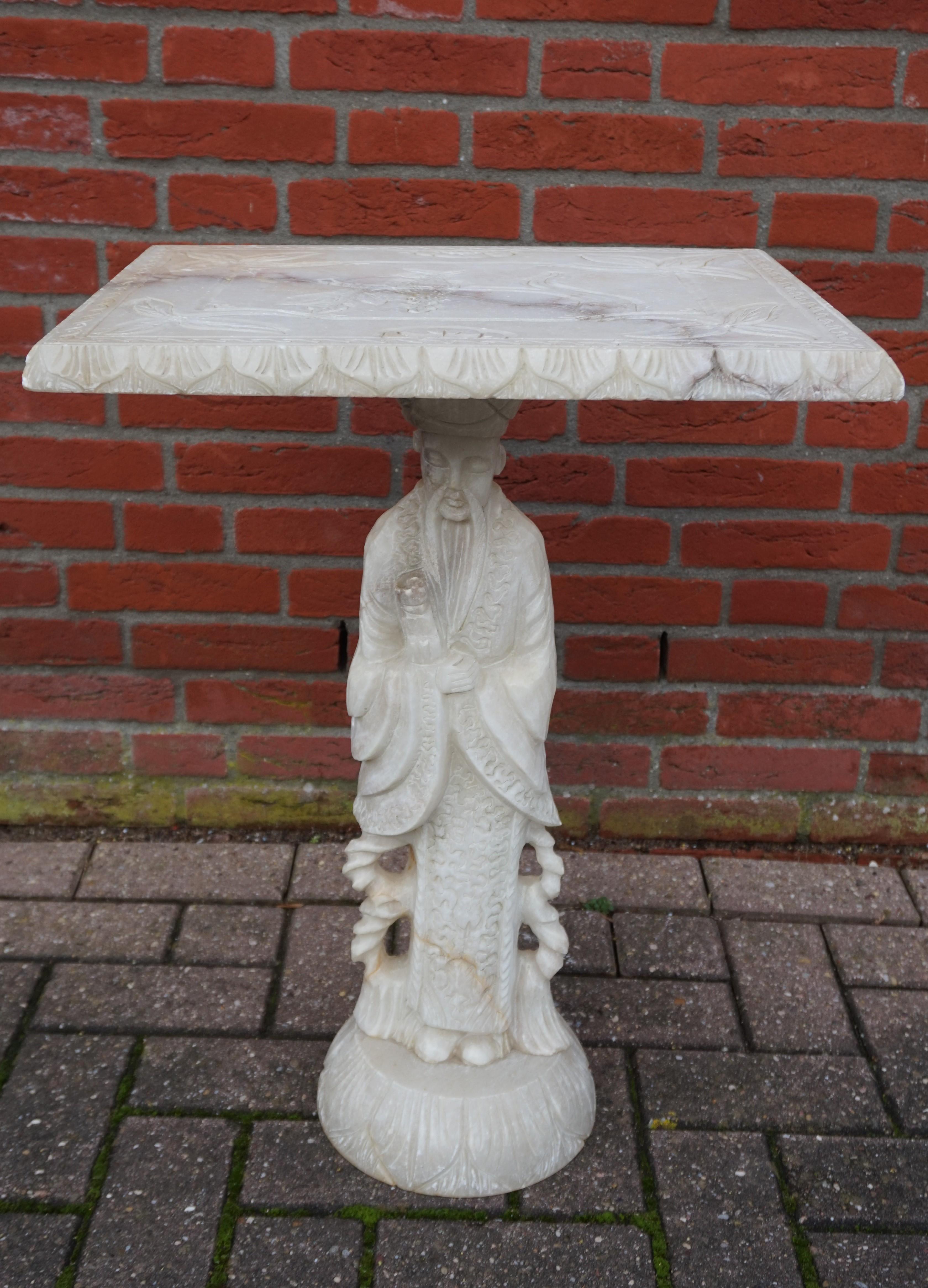 Rare and highly decorative, semi-antique side or end table.

We believe that the Asian philosopher that makes up the base or stem of this table is Confucius, but it could also be Lao Tzu (a.k.a. Laozi). This table is entirely hand carved out of