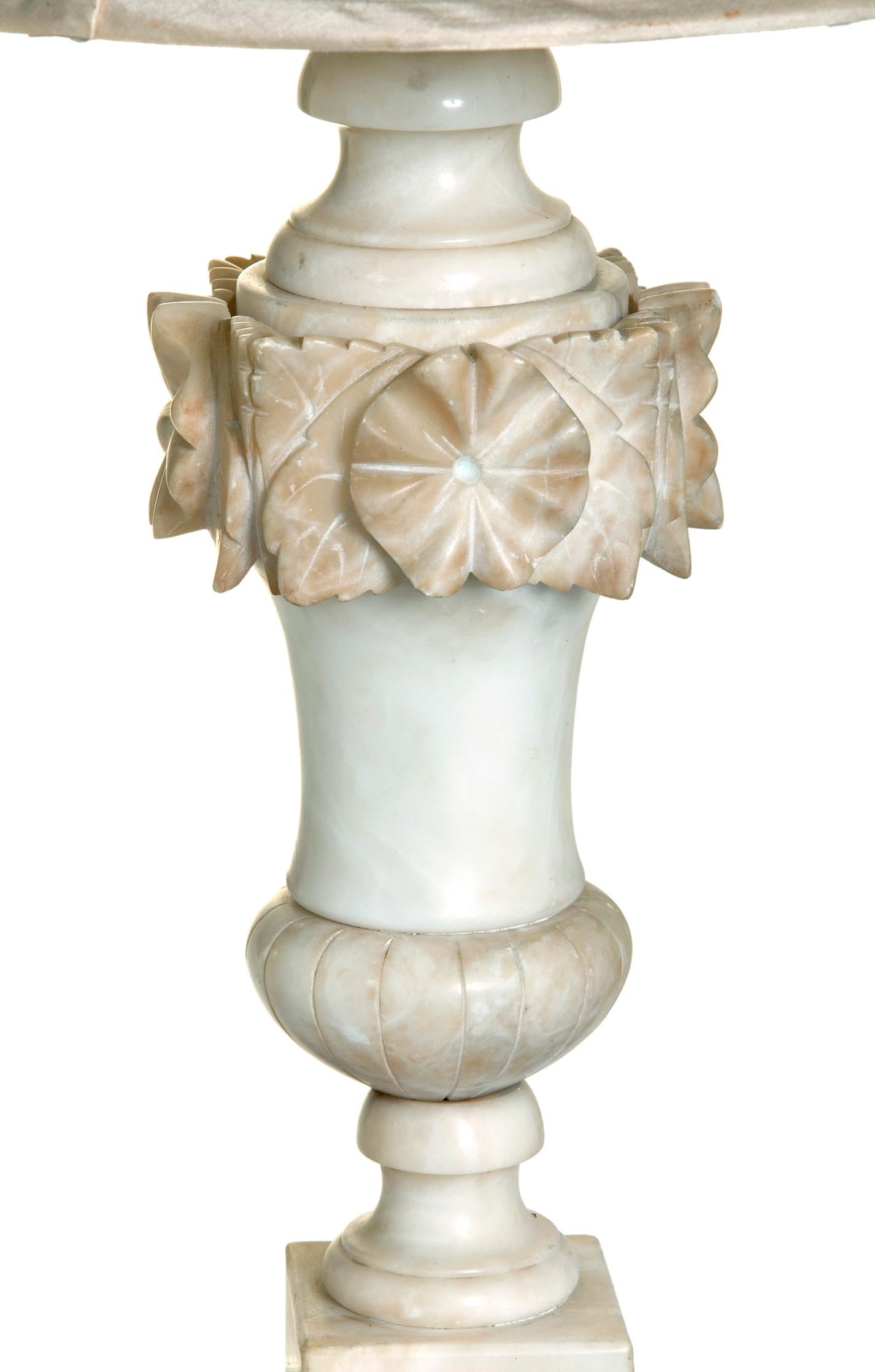 Early 20th C Italian hand-carved Alabaster Neoclassical baluster urn lamp embellished with a wreath of flowers around the top of the urn.
The blush tones & matter finish make this lamp a rare find.