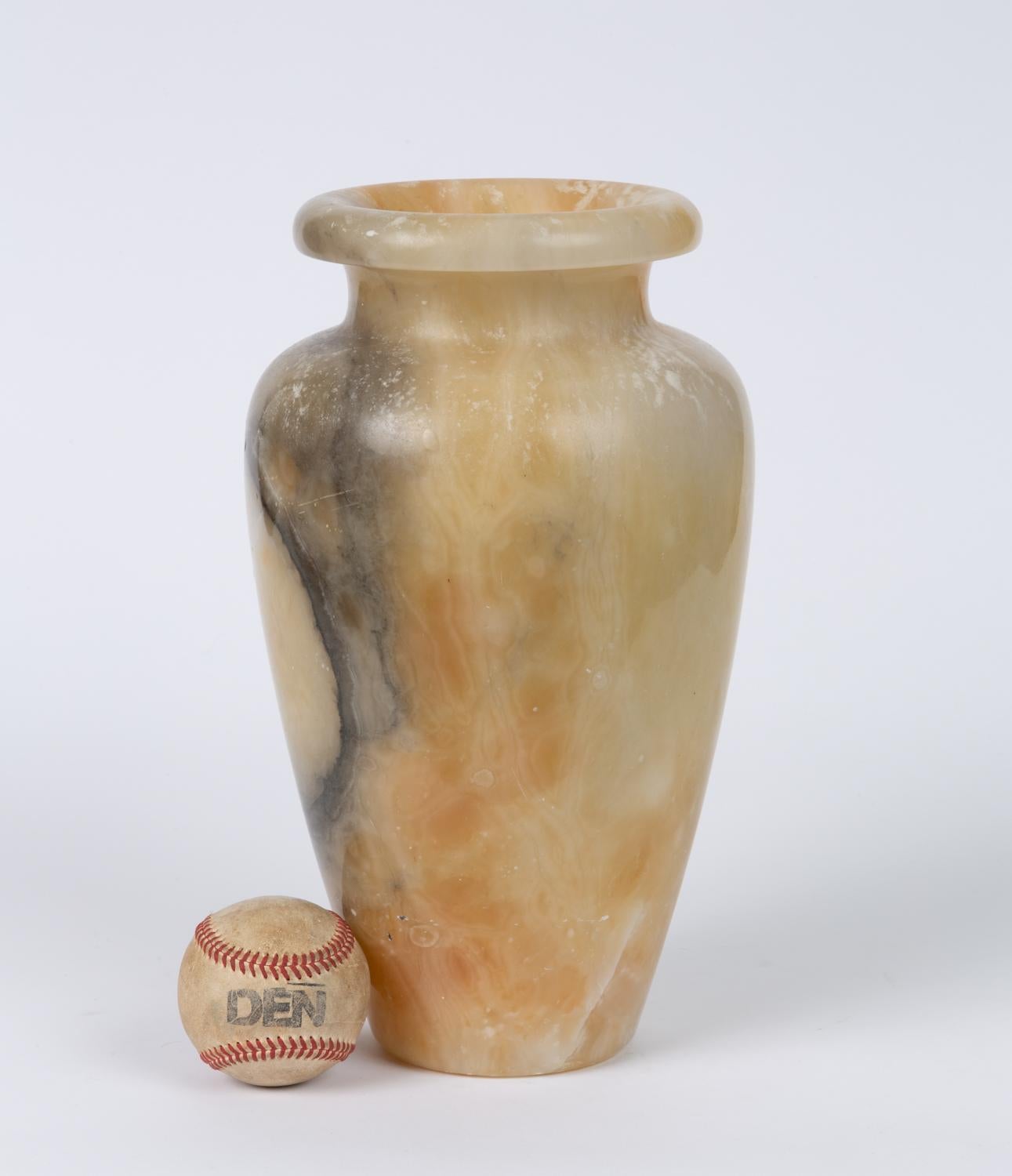 Vintage hand carved alabaster vase. It features an ovoid body gently tapering to a flat base, with broad shoulders and a disk rim. The short neck is concave and the interior well is hollowed.

Condition: Excellent original condition with no chips,