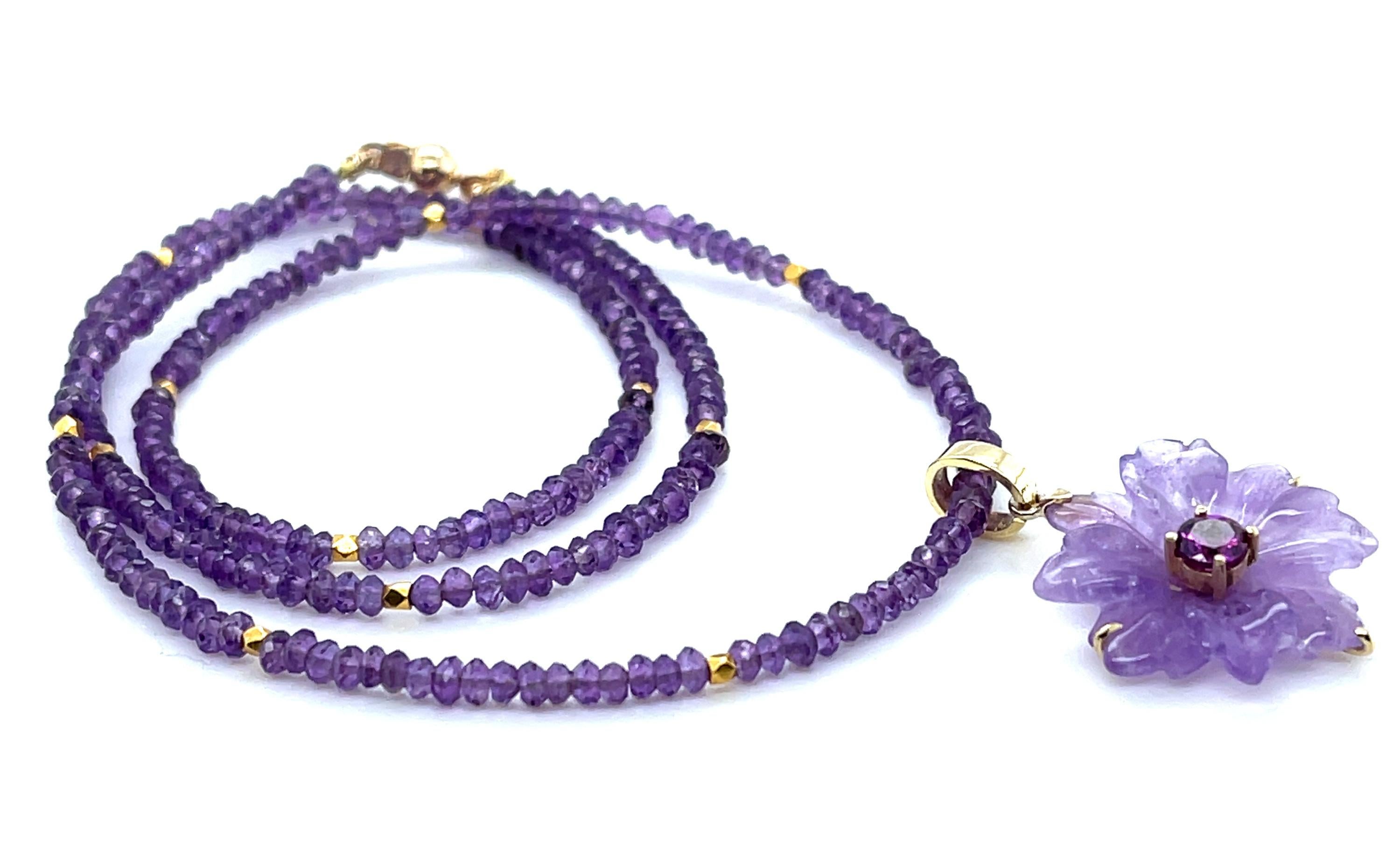 This unique necklace features a beautiful floral amethyst pendant set in 18k yellow gold on a strand of pastel and royal purple amethyst beads. The flower pendant has been hand carved from a single amethyst crystal with delicate purple color, and in