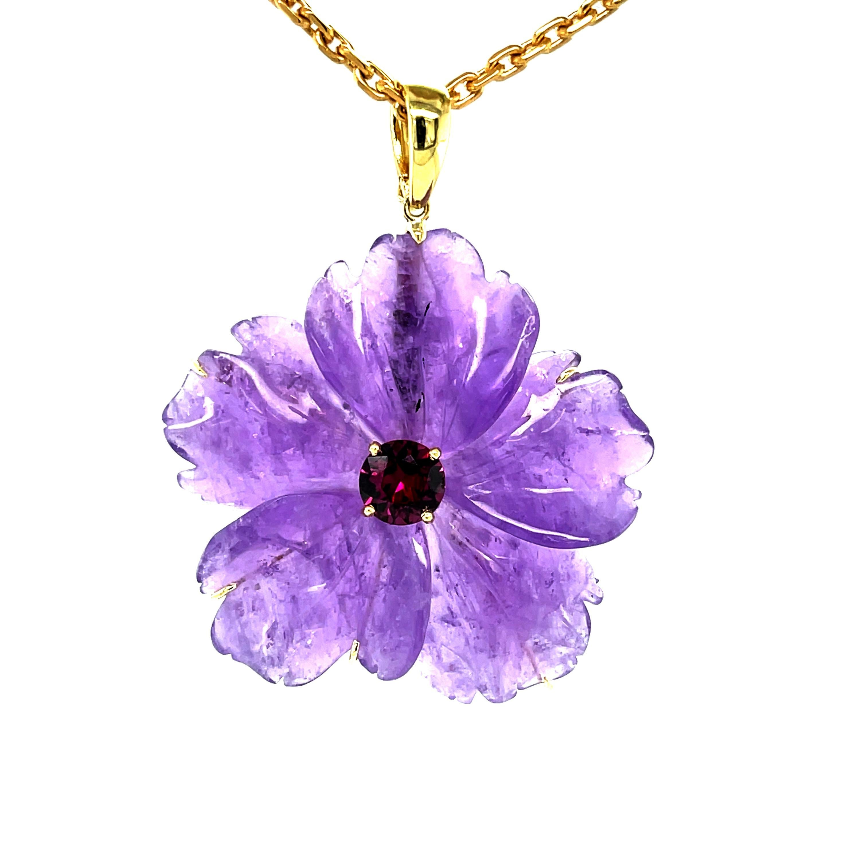 A beautifully hand carved amethyst flower is featured in this eye-catching 18k yellow gold necklace. The 5-petaled flower has wonderful dimensions and measures approximately  1-5/8