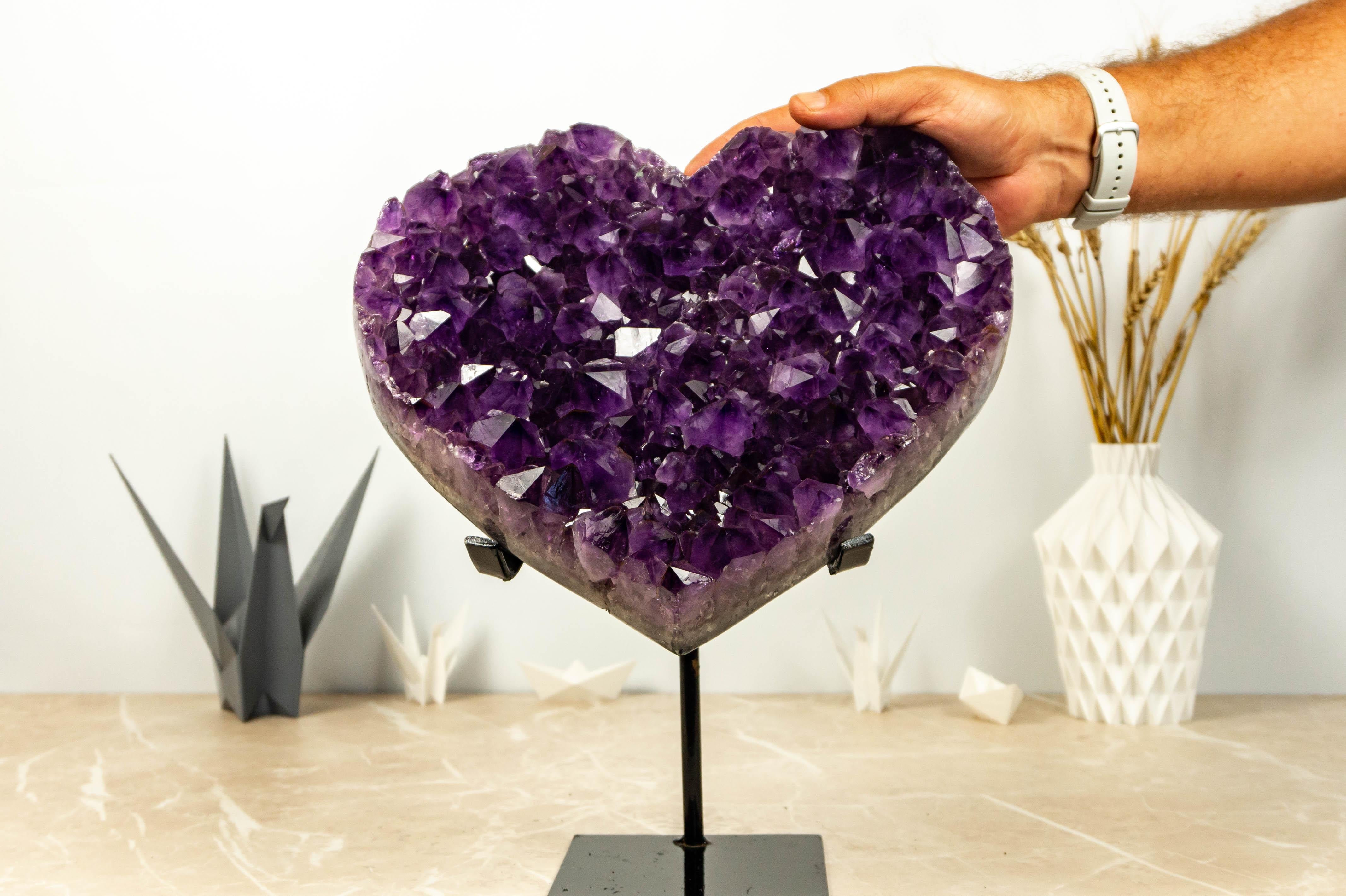 Stunning in every detail, this AAA Amethyst Heart showcases the deepest tone any amethyst can possess. With a large and translucent Amethyst Druzy naturally set in a beautiful green basalt, this combination creates a fascinating Amethyst Heart. It