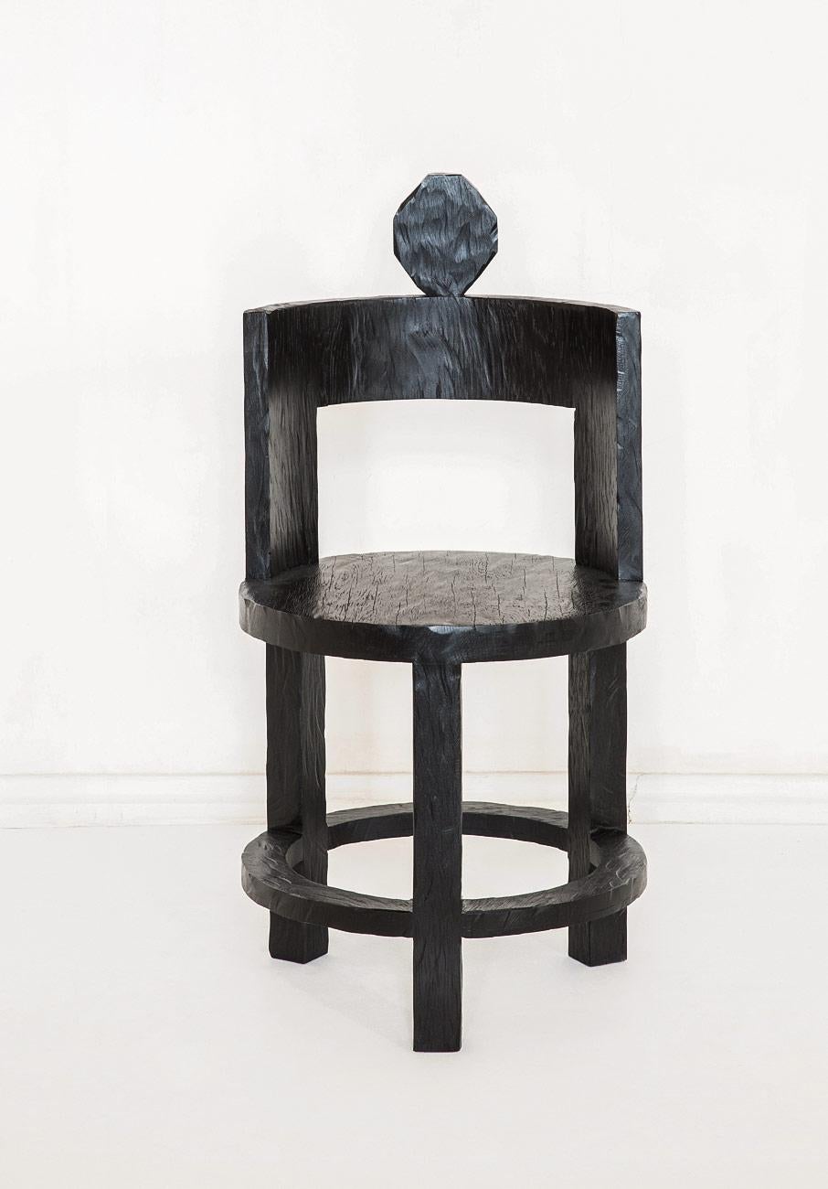 This hand-carved and blackened reclaimed oak chair, designed by Rooms Studio (from their 2018 Wild Minimalism collection), is inspired by the legacy of traditional Georgian craftsmanship. The Sculptural Chair is meticulously handcrafted of ancient