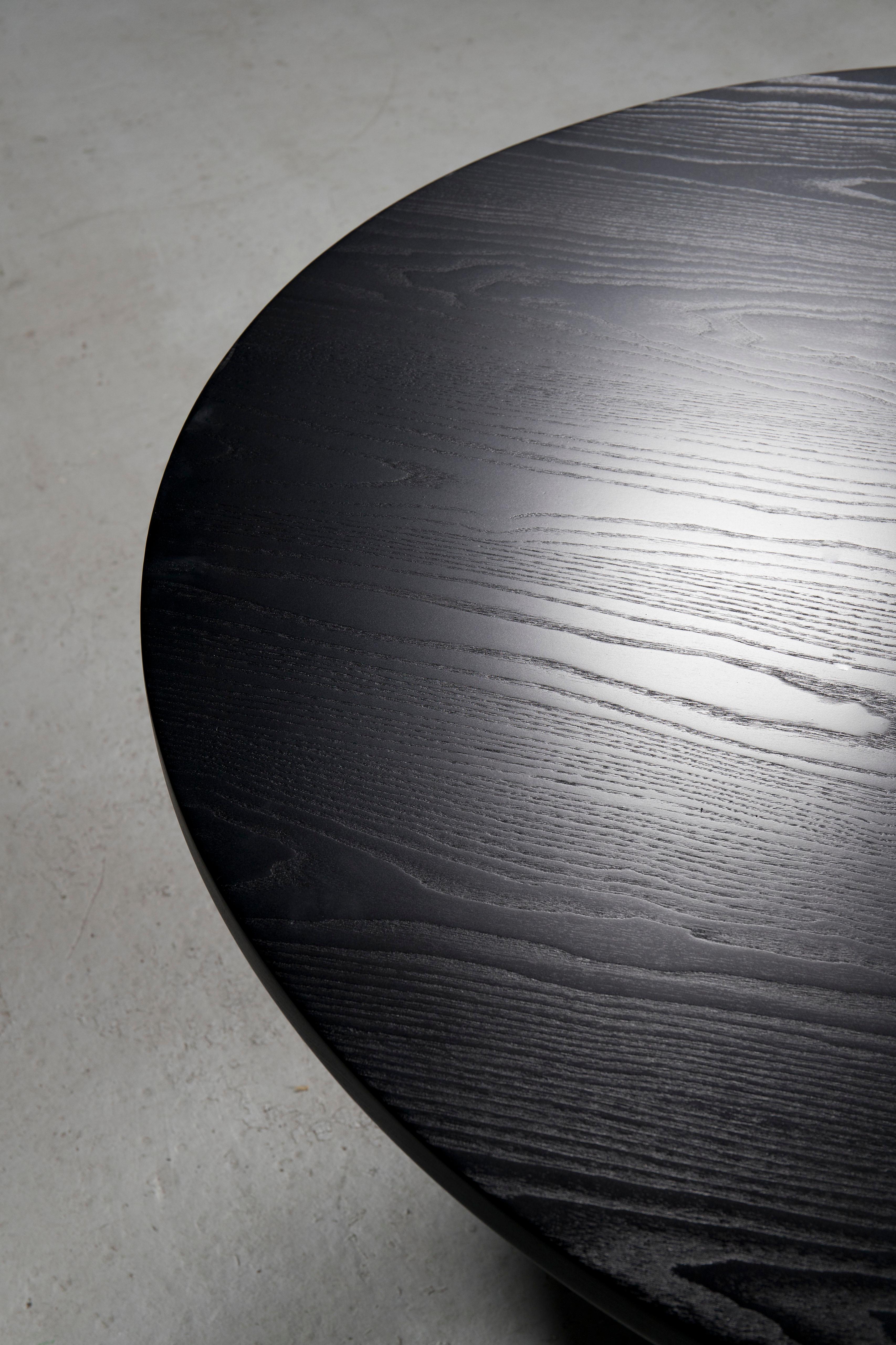 Hand sculpted and ebonized Ash round table with stack, laminated and carved base by contemporary artist Caleb Woodard, 2018.
This table can be viewed at my gallery - 532 W 25th St, NYC.