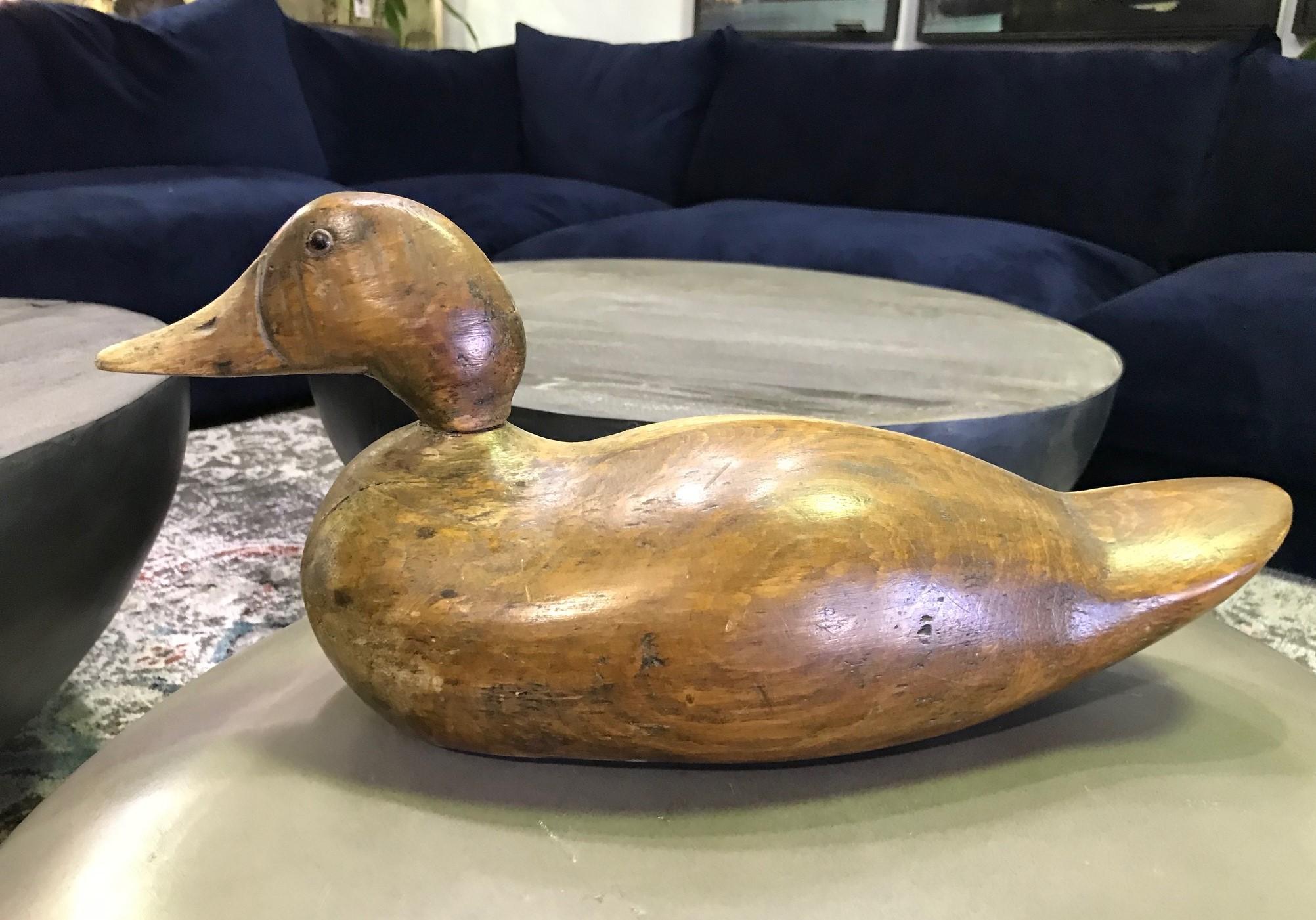 A fantastic early to mid-20th century handmade duck decoy with bead eyes. Beautiful dark wood and rich patina.

Would be a great addition to any collection or eye-catching stand-alone accent piece in about any setting.

Dimensions: 7.5