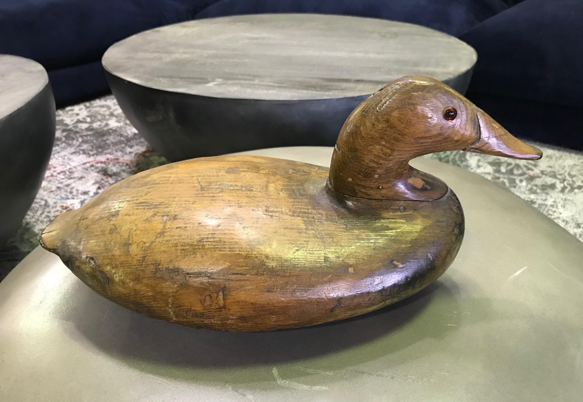 A fantastic early to mid-20th century handmade duck decoy with bead eyes. Beautiful dark wood and rich patina.

From an extensive collection of vintage or antique duck decoys including a pair by D. W. Nichol (which we have also listed).

Signed