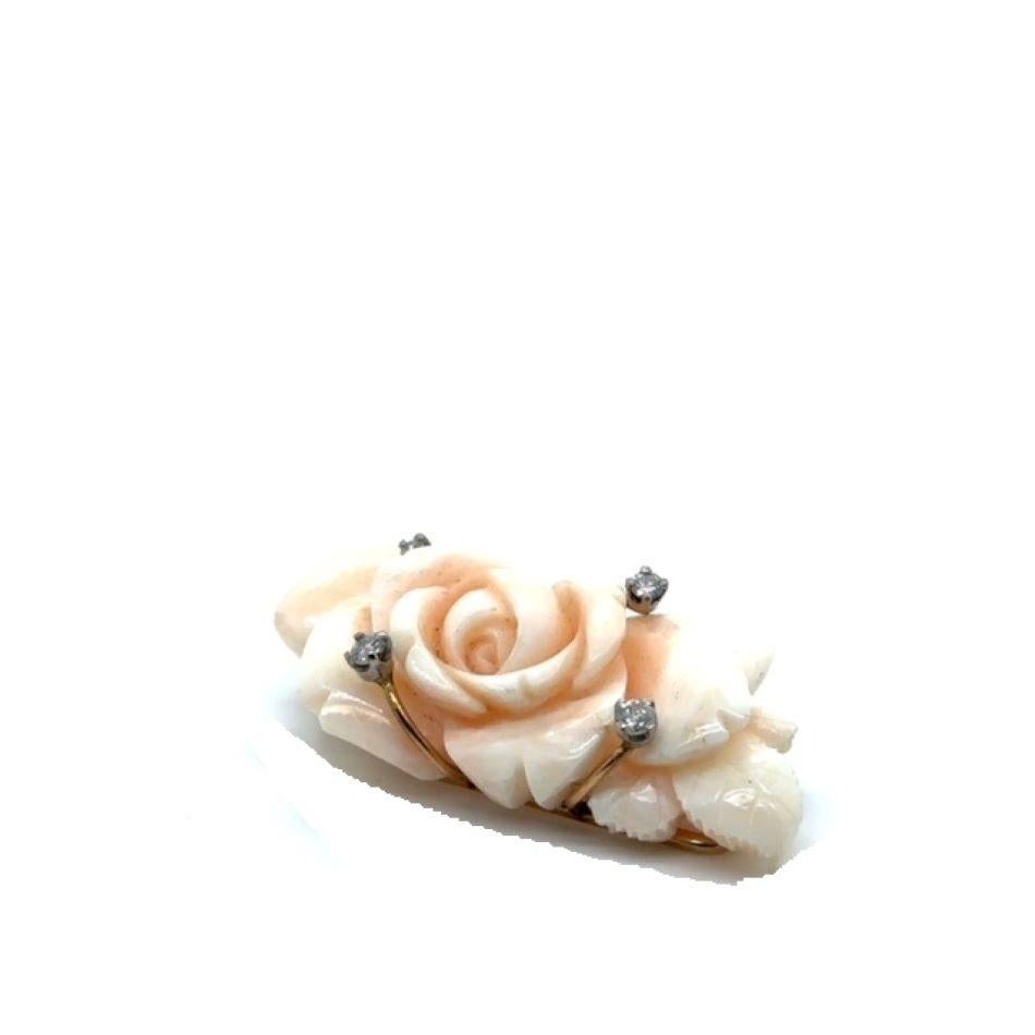 A WONDERFUL HAND MADE VINTAGE CIRCA 1960 14KARAT YELLOW AND WHITE GOLD BROOCH MOUNTED WITH A FINELY CARVED GEM QUALITY ANGEL SKIN CORAL IN A  “OPEN ROSE” DESIGN. THE BROOCH IS ACCENTED WITH 4 ROUND BRILIANT CUT DIAMONDS.

THE SHADING OF THE CORAL IS