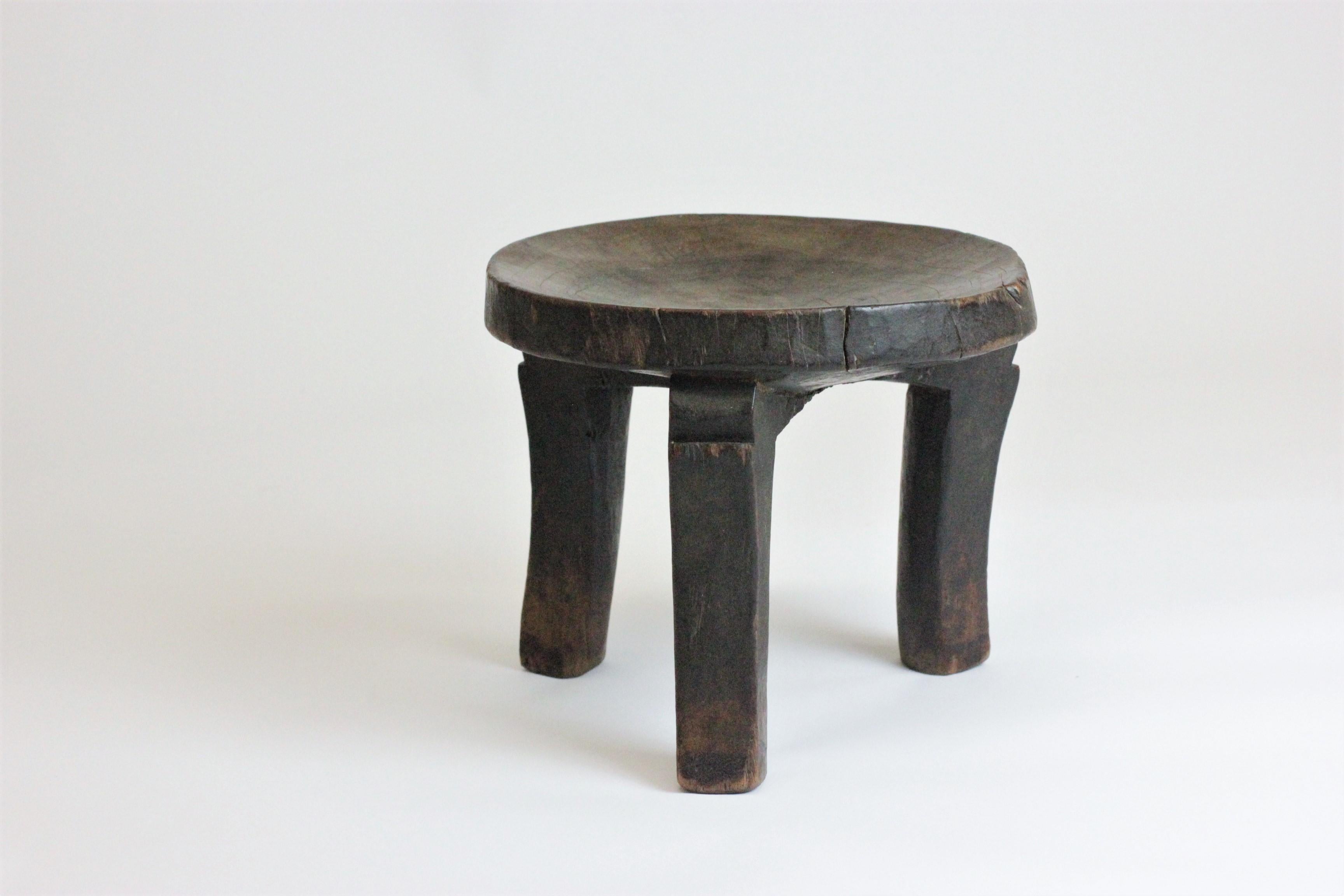 hand carved antique African decorative tribal footrest stool approximately 120 years old. This solid wood stool was originally handmade specifically for a person; such stools and Craft were typically viewed as a status symbol. The item remains