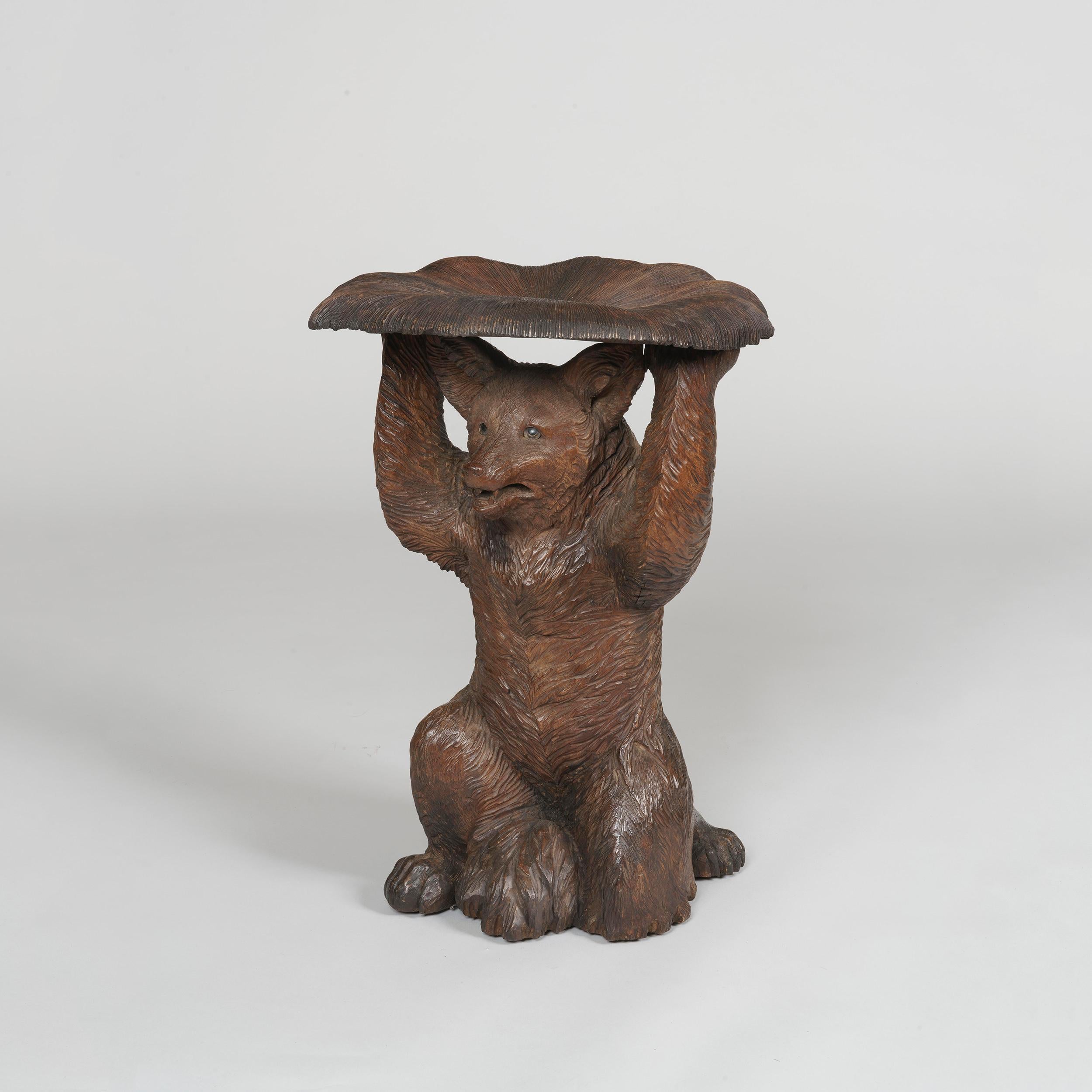 A 'Black Forest' fox stool

Constructed in a very well patinated and carved lindenwood, the kneeling fox having glass eyes, with monochrome naturalistic highlights; the seat carved to resemble a mushroom.
Brienz Area, circa 1900

Brienz, in the