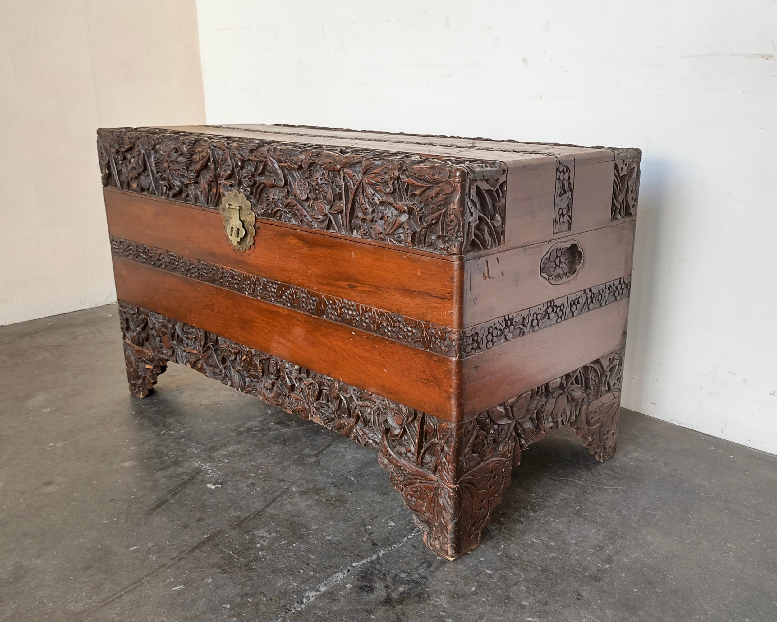 Hand-carved antique camphor wood chest. Lotus flower design, interior fragrant unfinished wood. Overall good vintage condition, wear throughout and scratches on top.

40