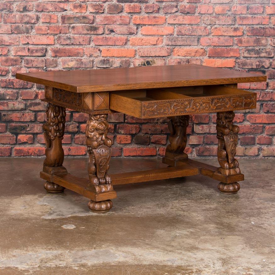 Impressive, hand carved lion and shield carved legs grab both your attention and imagination when you are in the same room as this inspiring desk. Each lion faces outward, so regardless of where this table sits in the room, its presence will be