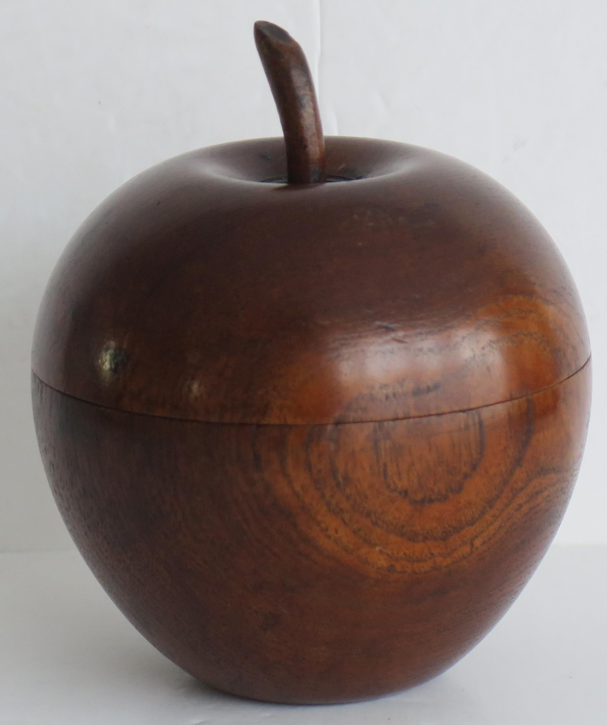 This is a hand worked Lidded box or Tea Caddy style box in the shape of an Apple, made from fruitwood and dating to the mid 20th century, Circa 1940.

The Apple shaped box has a lid with a short hand carved stalk. The lid is a very good push fit