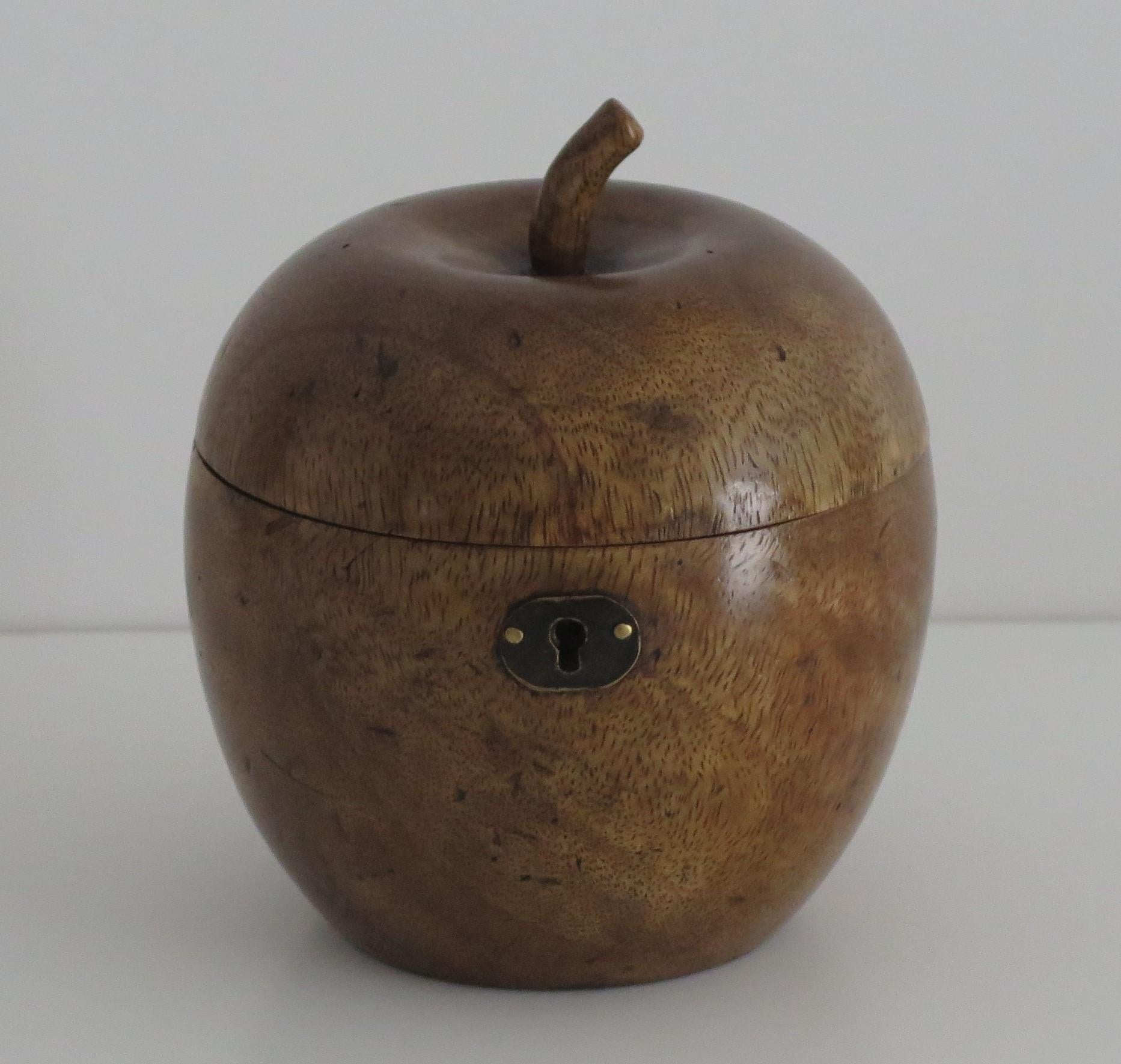 This is a hand made tea caddy Lidded box in the shape of an Apple, made from hardwood and dating to the 19th century.

The Apple shaped box has a hinged lid with a short hand carved stalk. The lid has a brass hinge and lock (sorry no key). The