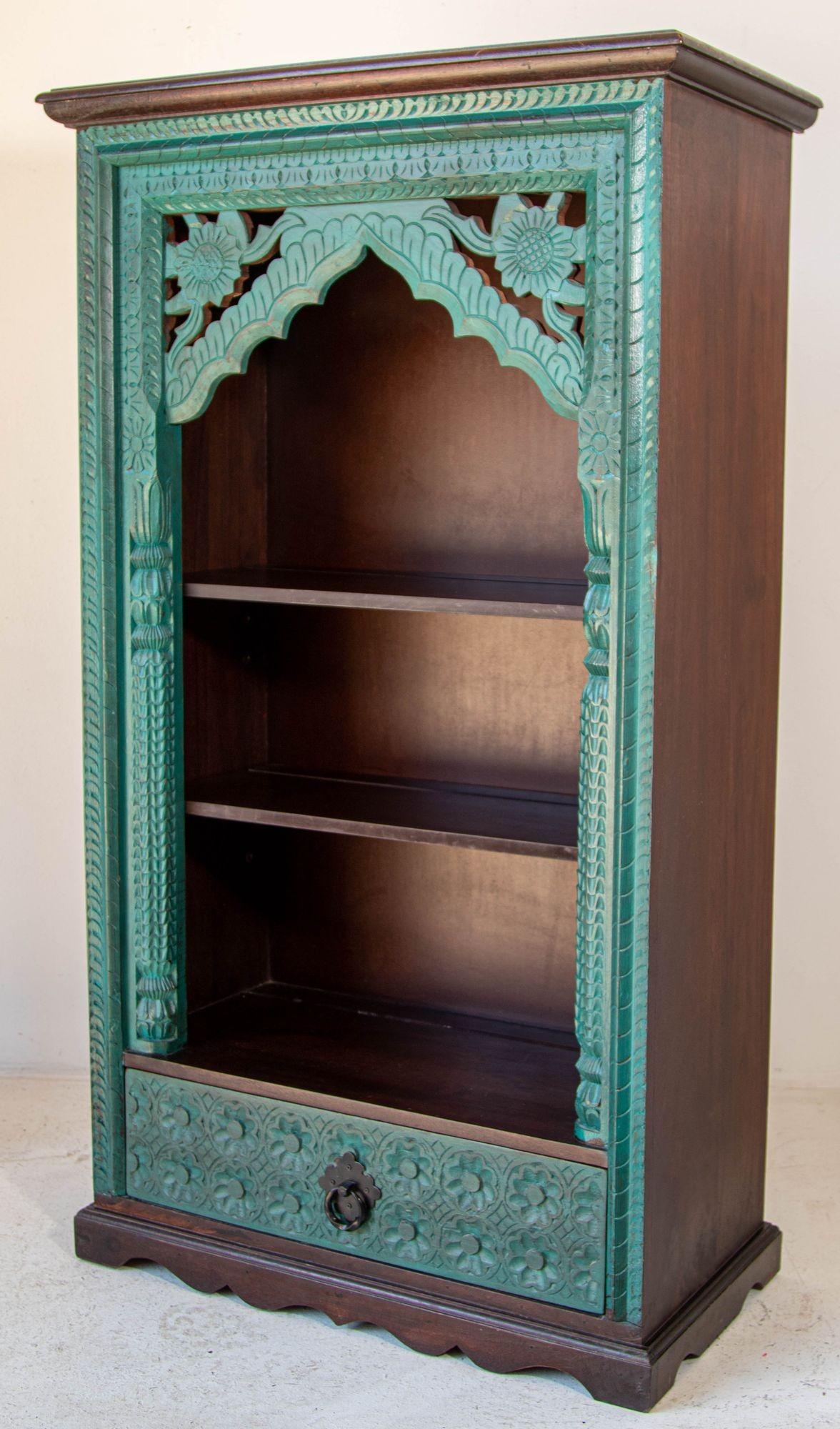 Vintage Hand-Carved Arch Bookshelf Wooden Cabinet in Rustic Blue antique distressed look.
Painted blue arch bookshelf with distressed finish.
Traditional and authentic Indian wooden display cabinet hand-carved with distressed blue wood finish.
This