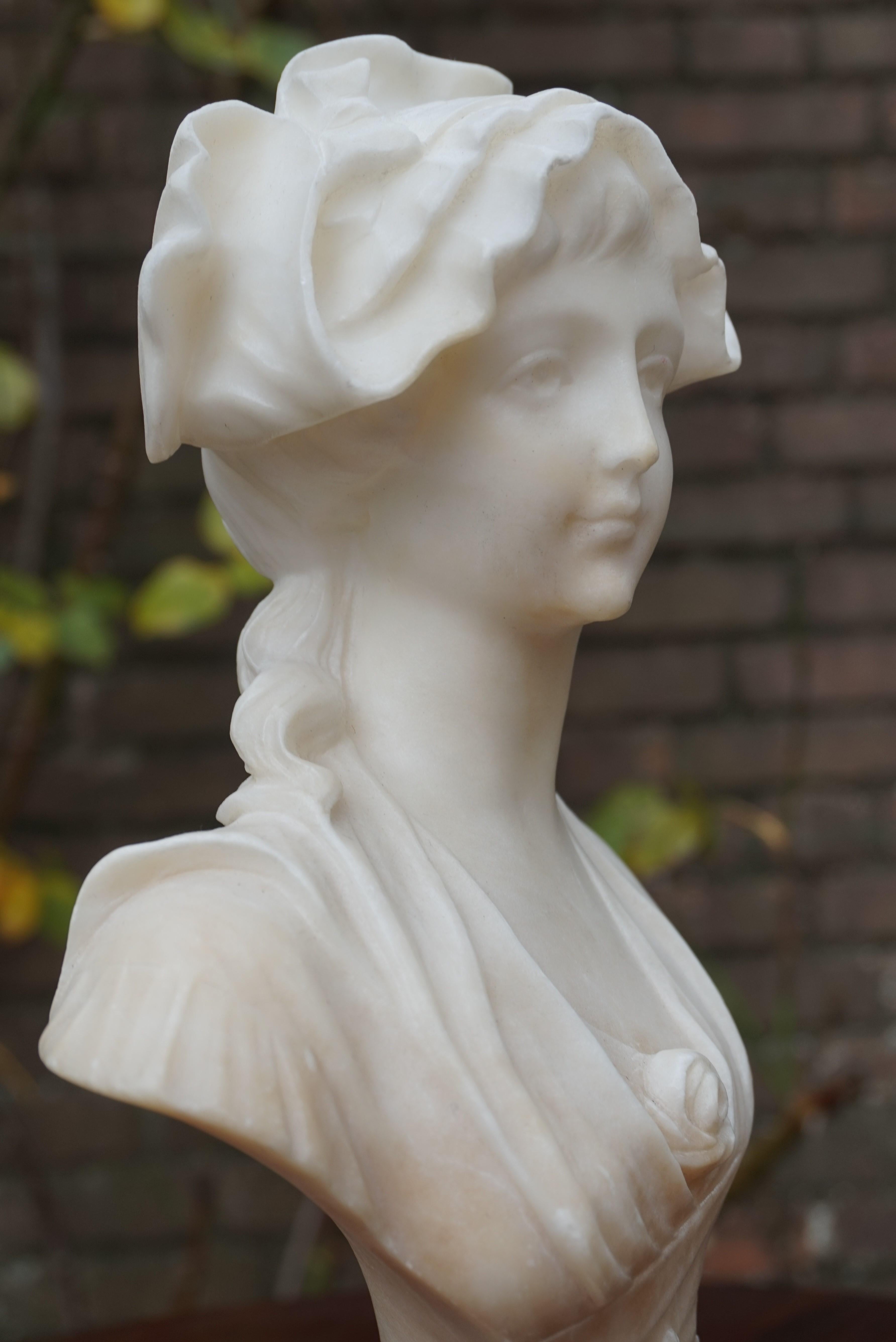 Small size and great quality, female bust sculpture with signature.

Judging from the perfect balance, the details and the marvelous facial expression of this antique Art Nouveau bust, this is the work of a master sculptor. The pleasantly calm look