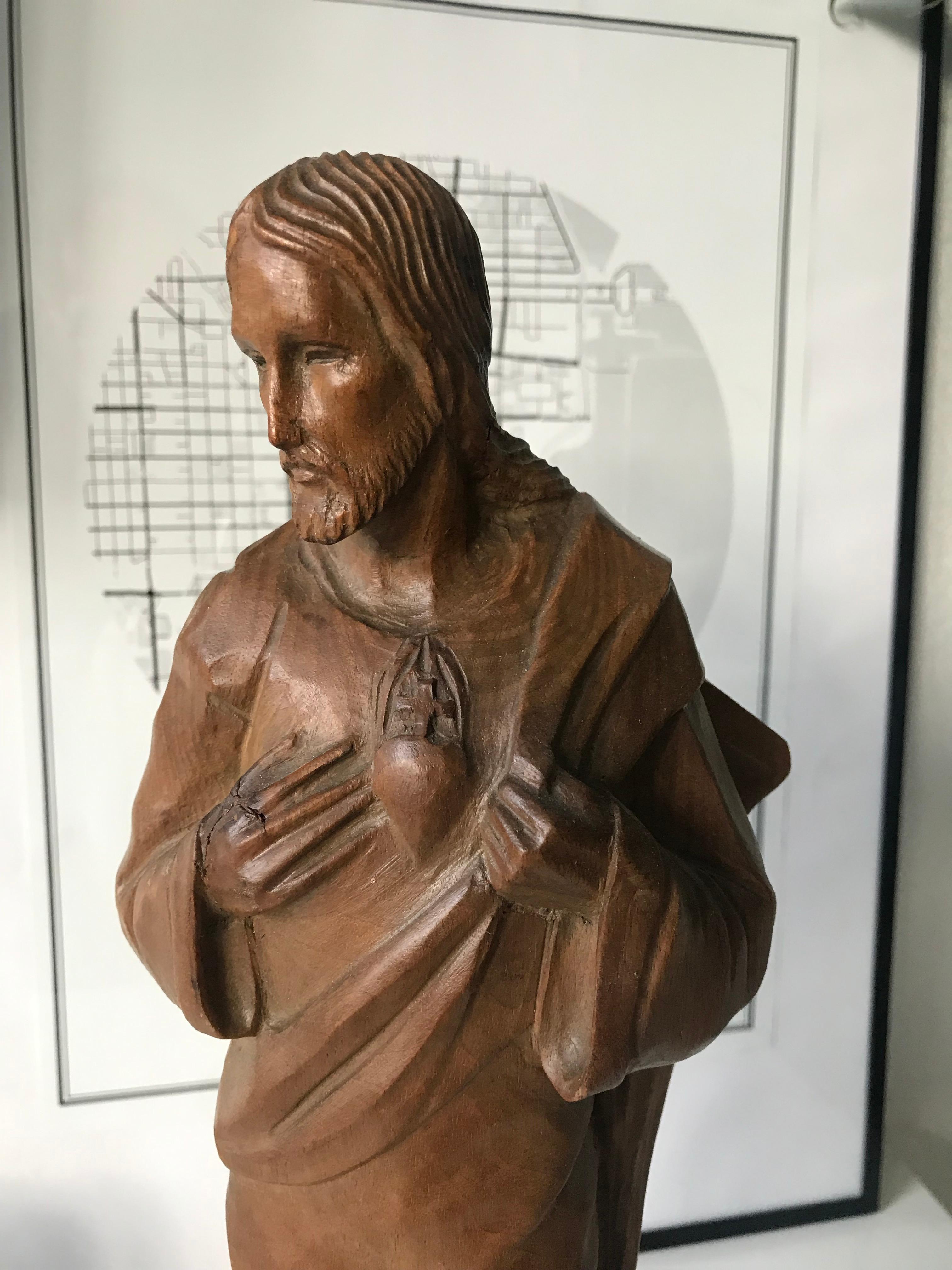 Handcrafted work of religious art with a marvelous patina.

This finely carved, wooden statuette of Jesus dates from the earliest years of the 20th century. Well taken care of it is in very good condition and the geometric marble base makes it stand